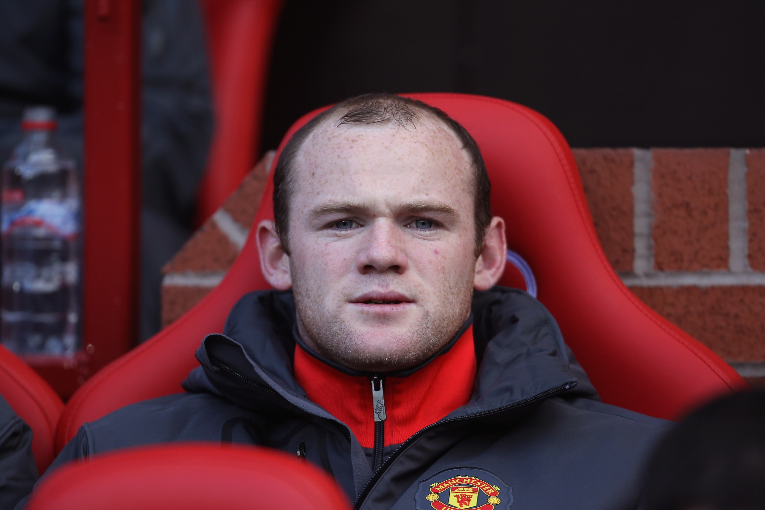 MANCHESTER, ENGLAND - OCTOBER 16:  Wayne Rooney of Manchester United looks on from the bench prior to the Barclays Premier League match between Manchester United and West Bromwich Albion at Old Trafford on October 16, 2010 in Manchester, England.  (Photo