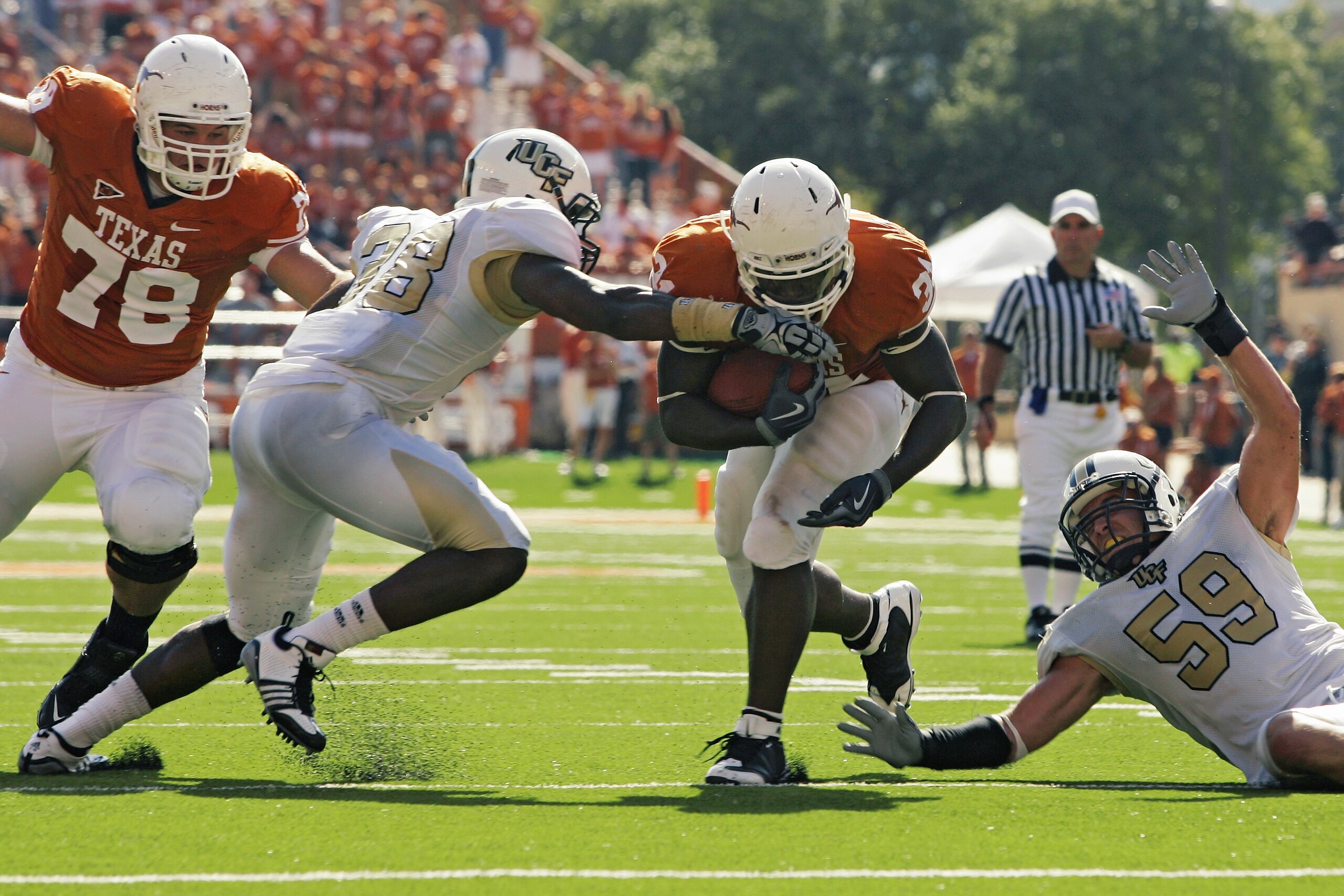 AUSTIN, TX - NOVEMBER 07:  Running back Cody Johnson #31 of the Texas Longhorns runs with the ball against linebackers Derrick Hallman #38 and Cory Hogue #59 of the UCF Knights on November 7, 2009 at Darrell K Royal - Texas Memorial Stadium in Austin, Tex