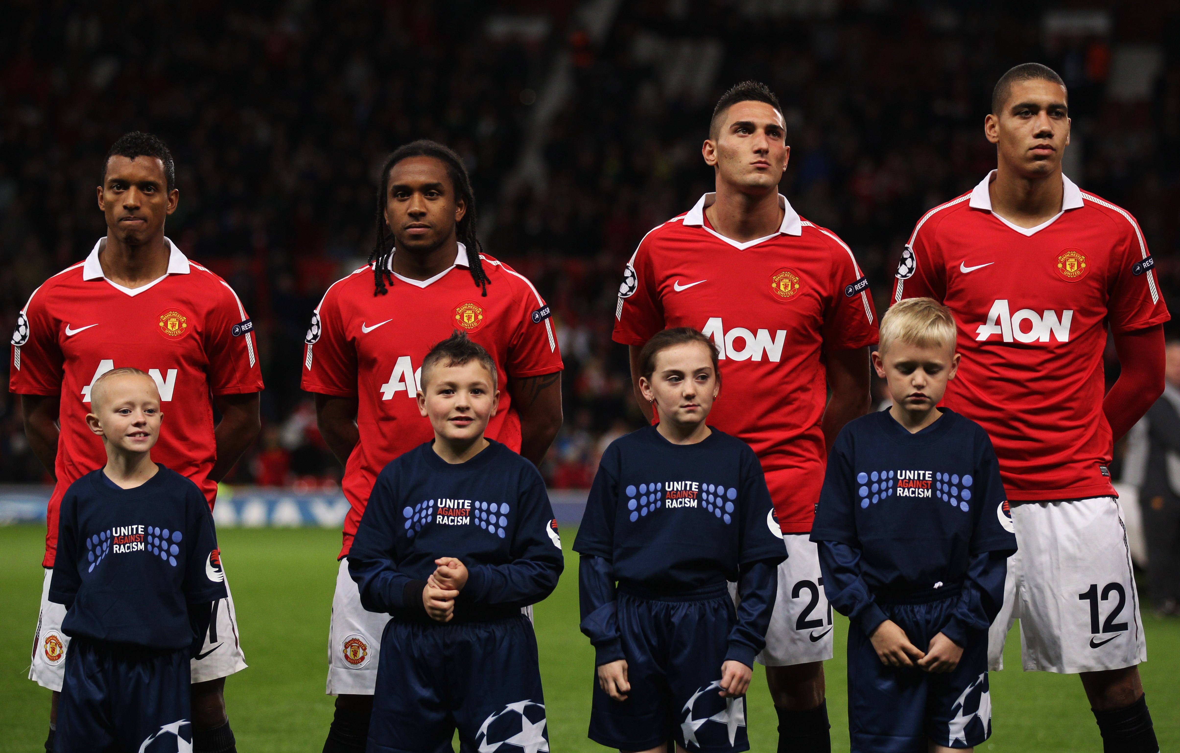 MANCHESTER, ENGLAND - OCTOBER 20:  (L-R) Luis Nani, Anderson, Federico Macheda and Chris Smalling of Manchester United line up with mascots prior to the UEFA Champions League Group C match between Manchester United and Bursaspor Kulubu at Old Trafford on