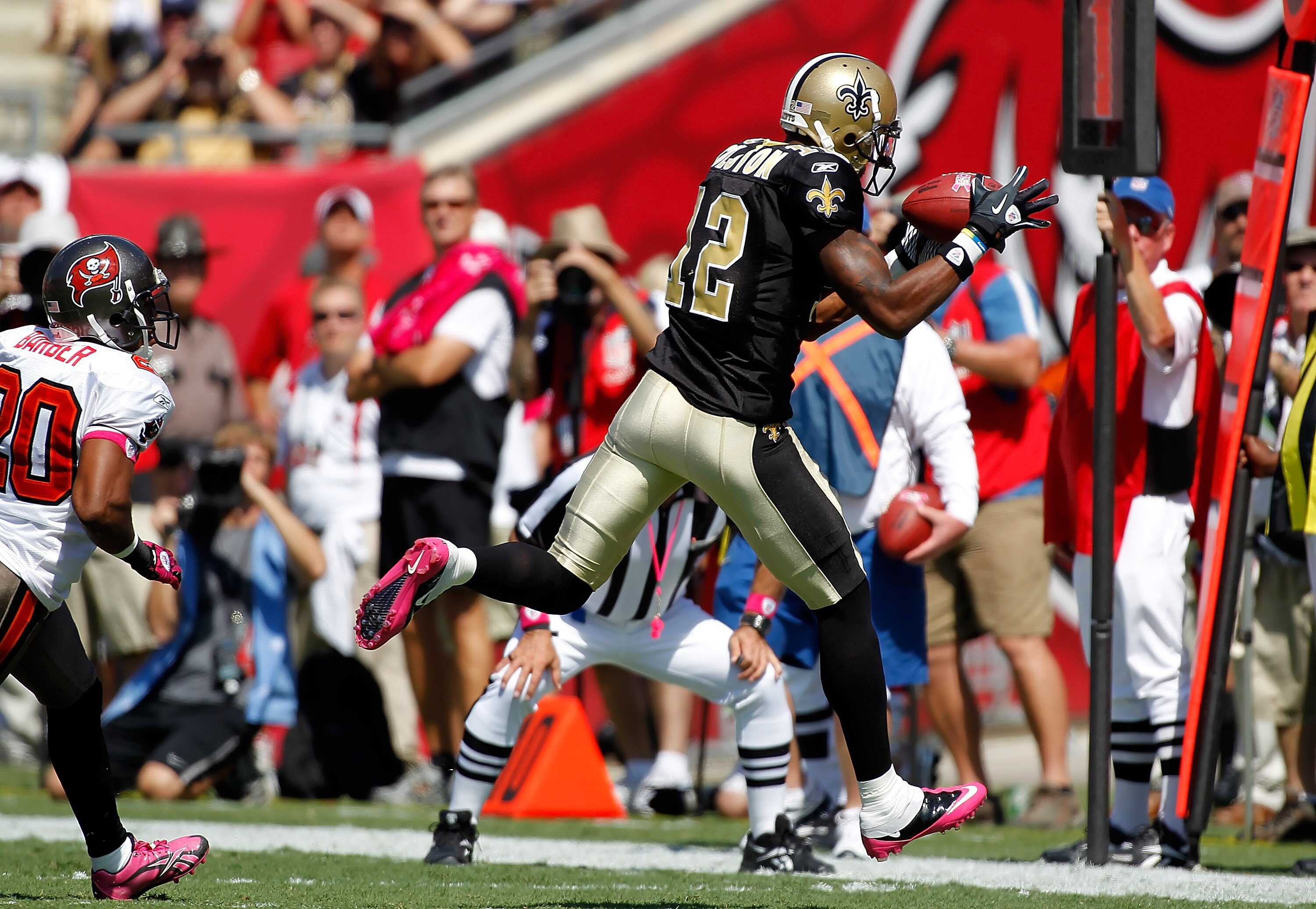 TAMPA, FL - OCTOBER 17:  Receiver Marques Colston #12 of the New Orleans Saints catches a pass in front of defensive back Ronde Barber #20 of the Tampa Bay Buccaneers during the game at Raymond James Stadium on October 17, 2010 in Tampa, Florida.  (Photo