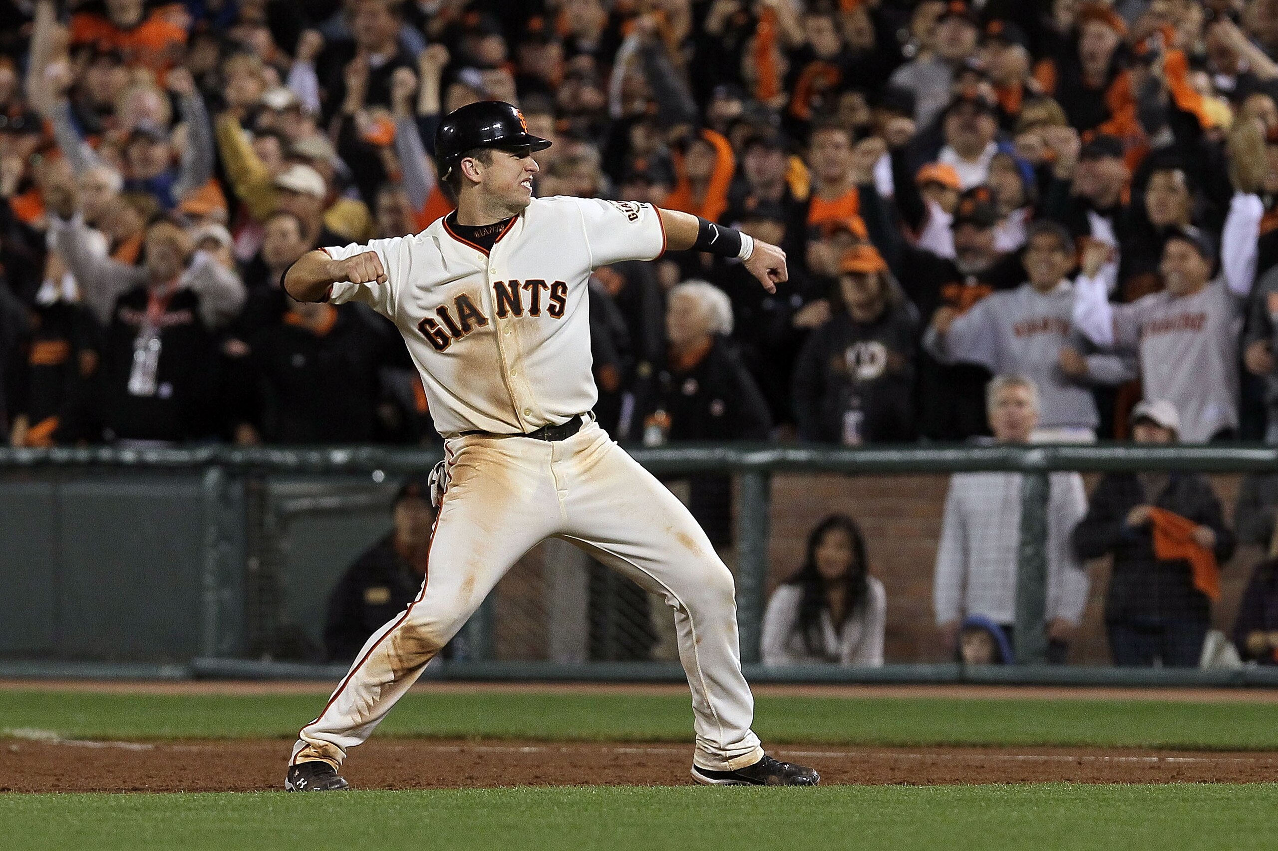 SAN FRANCISCO - OCTOBER 20:  Buster Posey #28 of the San Francisco Giants reacts to Juan Uribe #5 hitting a sacrifice fly, scoring Aubrey Huff #17 to win 6-5 over the Philadelphia Phillies in Game Four of the NLCS during the 2010 MLB Playoffs at AT&T Park