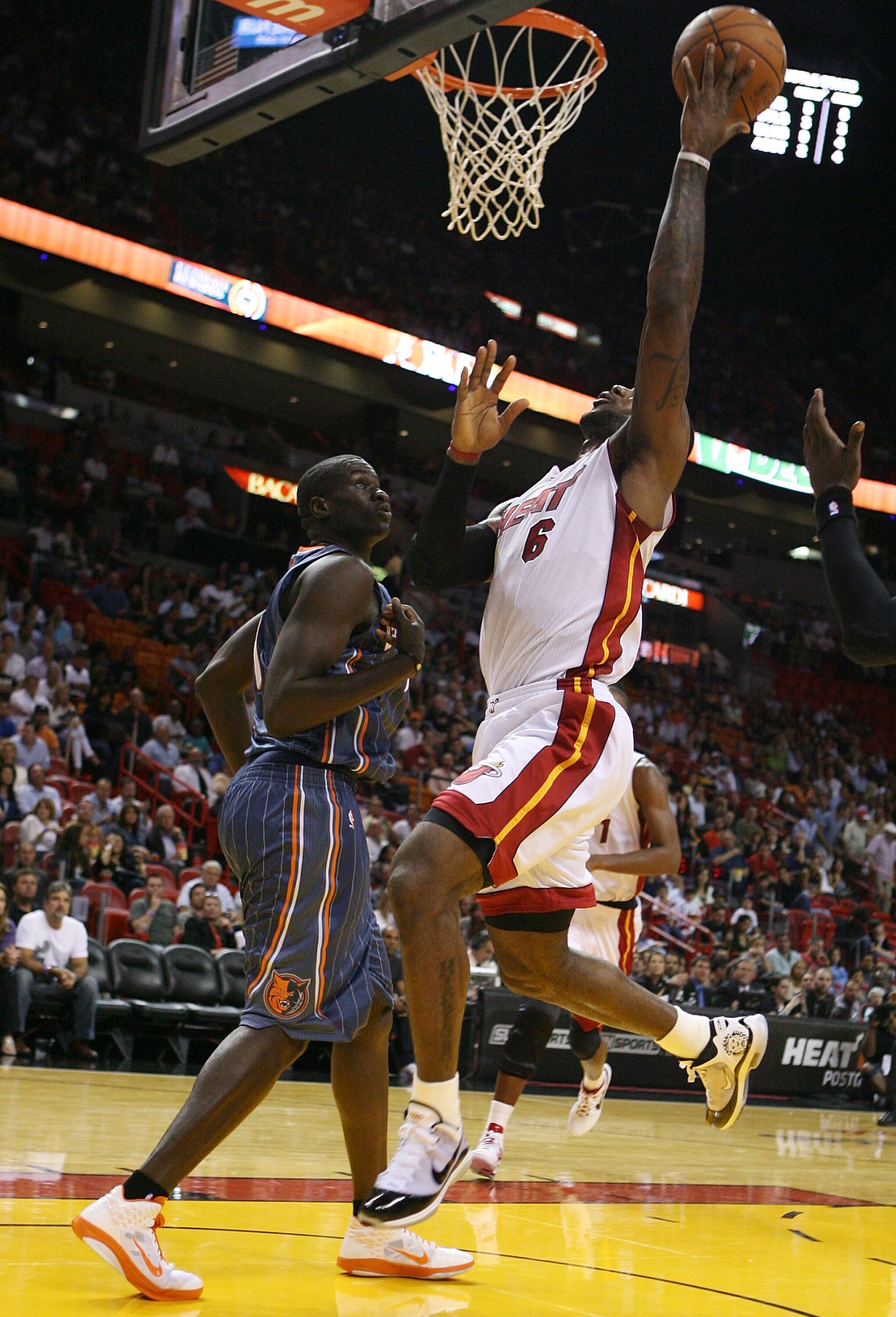 MIAMI - OCTOBER 18:  Forward LeBron James #6 of the Miami Heat is fouled by Forward Boris Diaw #32 of the Charlotte Bobcats on October 18, 2010 in Miami, Florida.  (Photo by Marc Serota/Getty Images)