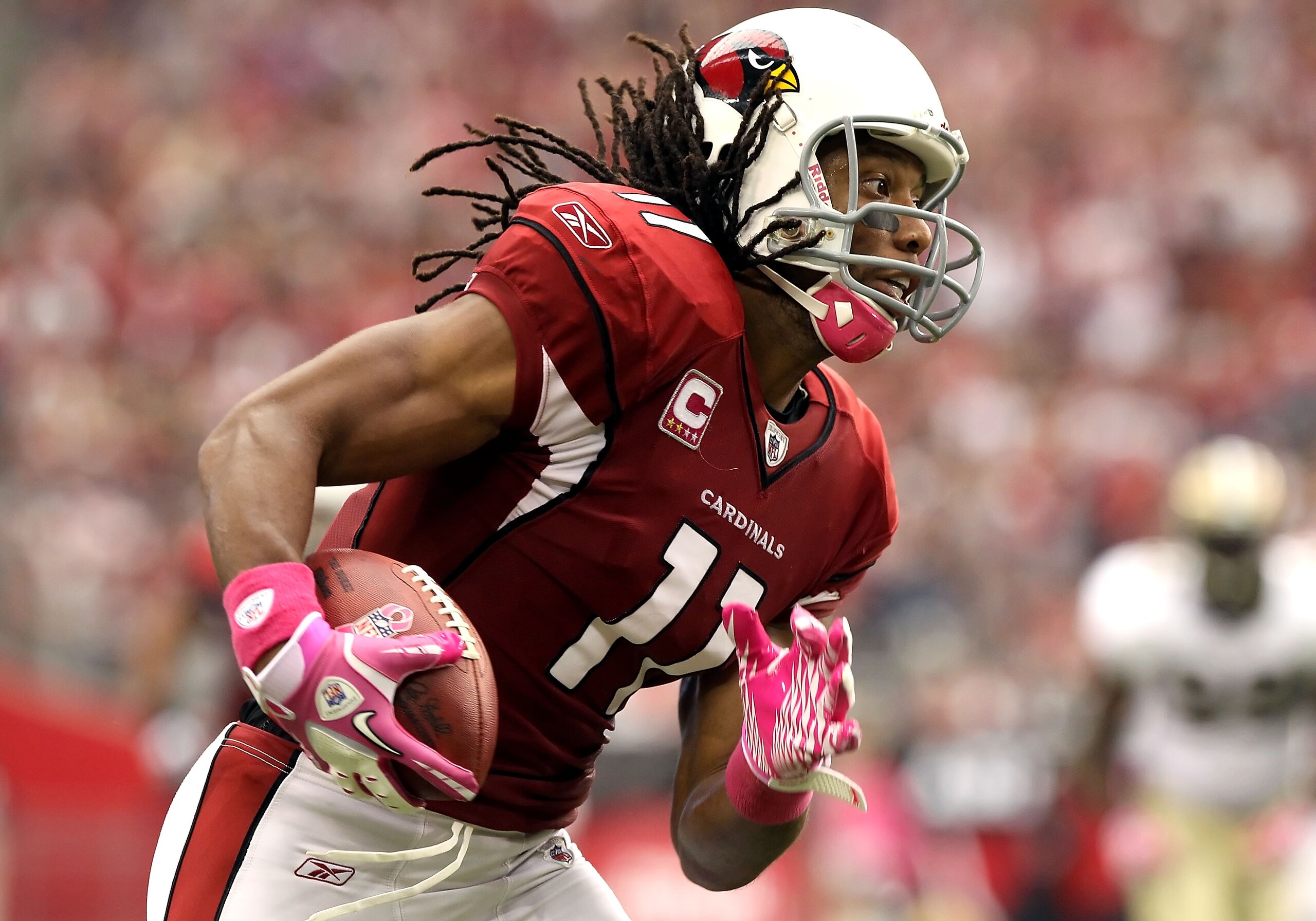 GLENDALE, AZ - OCTOBER 10:  Wide receiver Larry Fitzgerald #11 of the Arizona Cardinals runs with the football after a reception against the New Orleans Saints during the NFL game at the University of Phoenix Stadium on October 10, 2010 in Glendale, Arizo