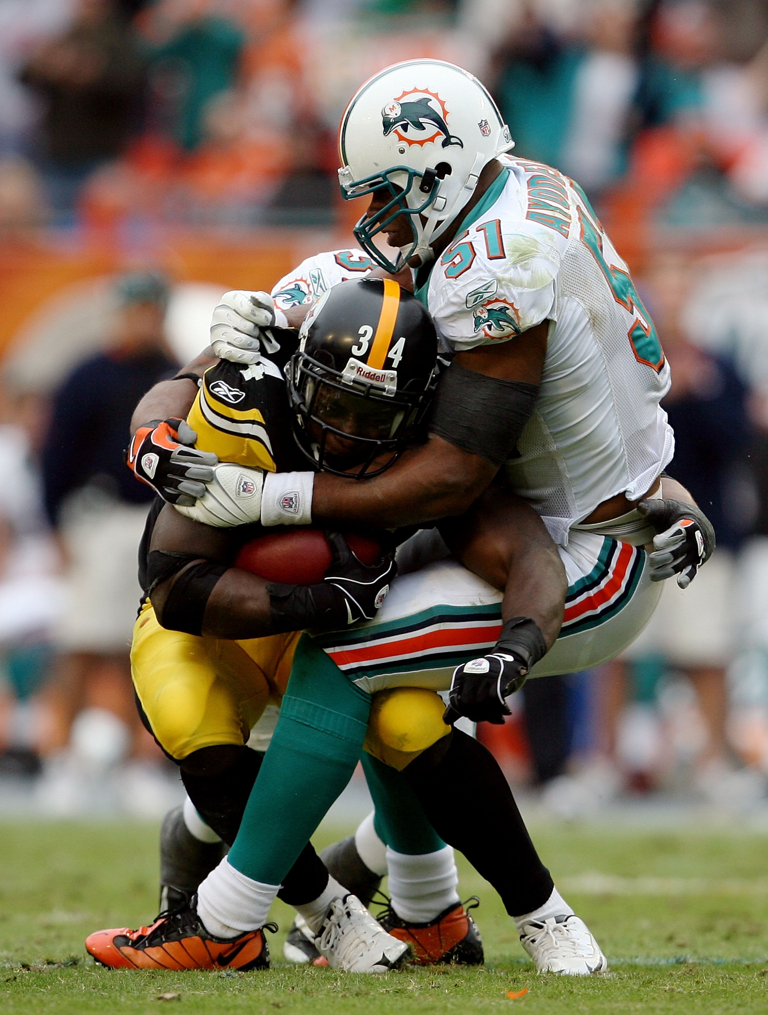 MIAMI - JANUARY 03:  Running back Rashard Mendenhall #34 of the Pittsburgh Steelers is brought down by linebacker Akin Ayodele #51 of the Miami Dolphins at Land Shark Stadium on January 3, 2010 in Miami, Florida. The Steelers defeated the Dolphins 30-24.