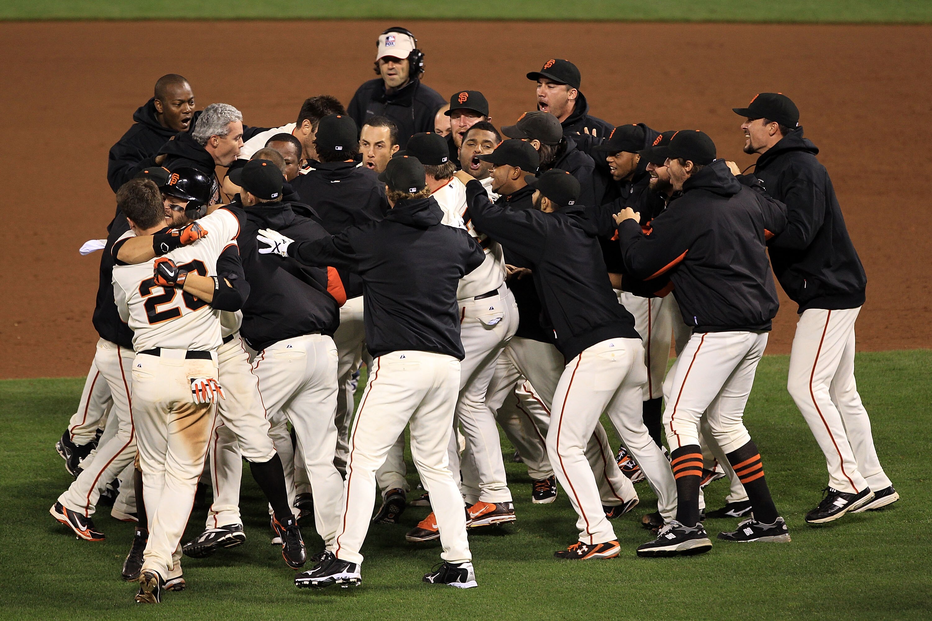 SAN FRANCISCO - OCTOBER 20:  The San Francisco Giants celebrate after a sacrifice fly by Juan Uribe #5 scored Aubrey Huff #17 to win 6-5 over the Philadelphia Phillies in Game Four of the NLCS during the 2010 MLB Playoffs at AT&T Park on October 20, 2010