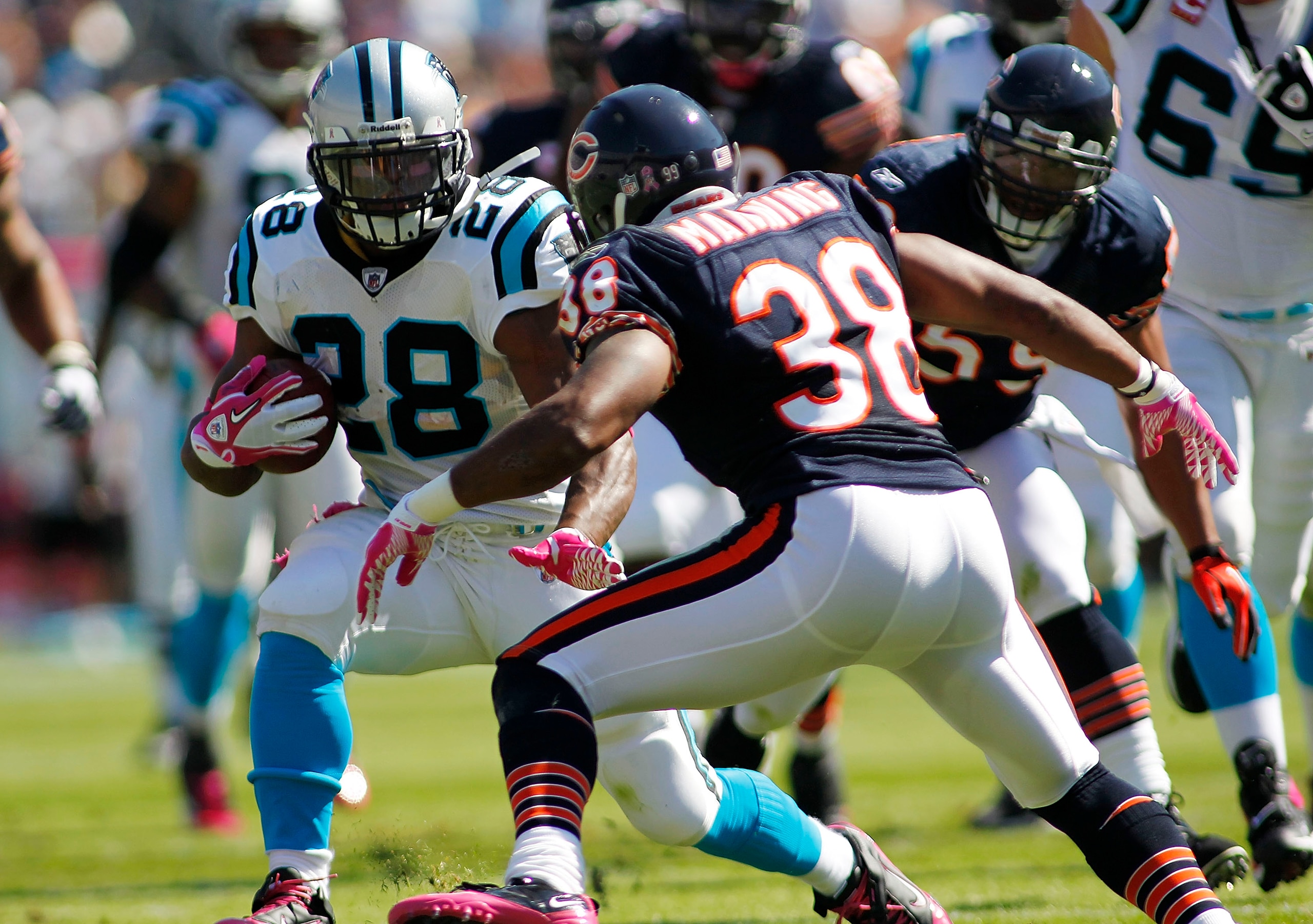 CHARLOTTE, NC - OCTOBER 10: Running back Jonathan Stewart #28 of the Carolina Panthers runs with the ball as safety Danieal Manning #38 of the Chicago Bears defends at Bank of America Stadium on October 10, 2010 in Charlotte, North Carolina. (Photo by Geo