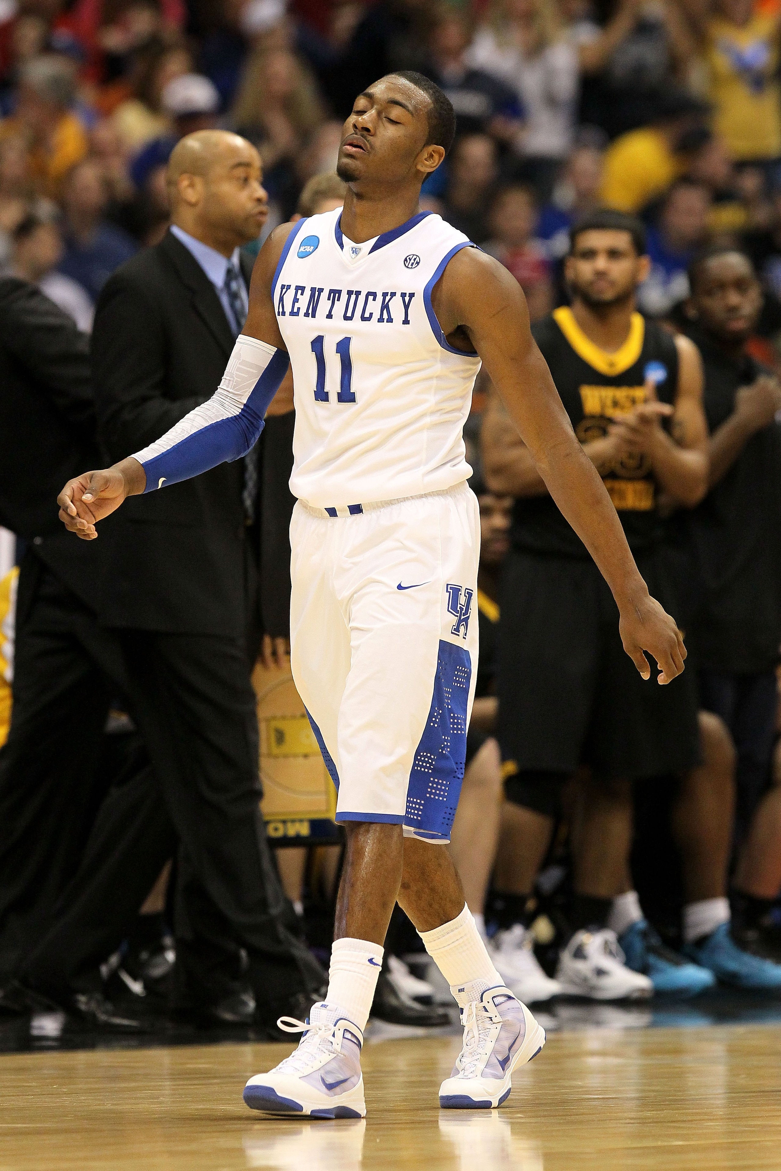 SYRACUSE, NY - MARCH 27:  John Wall #11 of the Kentucky Wildcats walks towards the bench against the West Virginia Mountaineers during the east regional final of the 2010 NCAA men's basketball tournament at the Carrier Dome on March 27, 2010 in Syracuse,