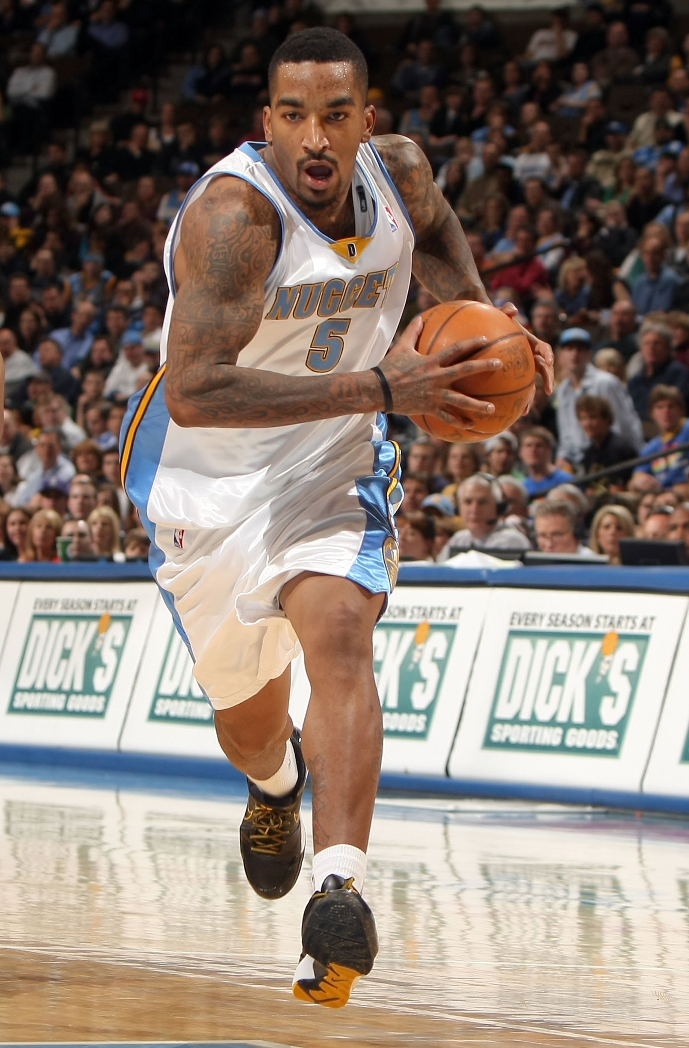 DENVER - JANUARY 05:  J.R. Smith #5 of the Denver Nuggets drives to the basket against the Golden State Warriors at the Pepsi Center on January 5, 2010 in Denver, Colorado. The Nuggets defeated the Warriors 123-122. NOTE TO USER: User expressly acknowledg