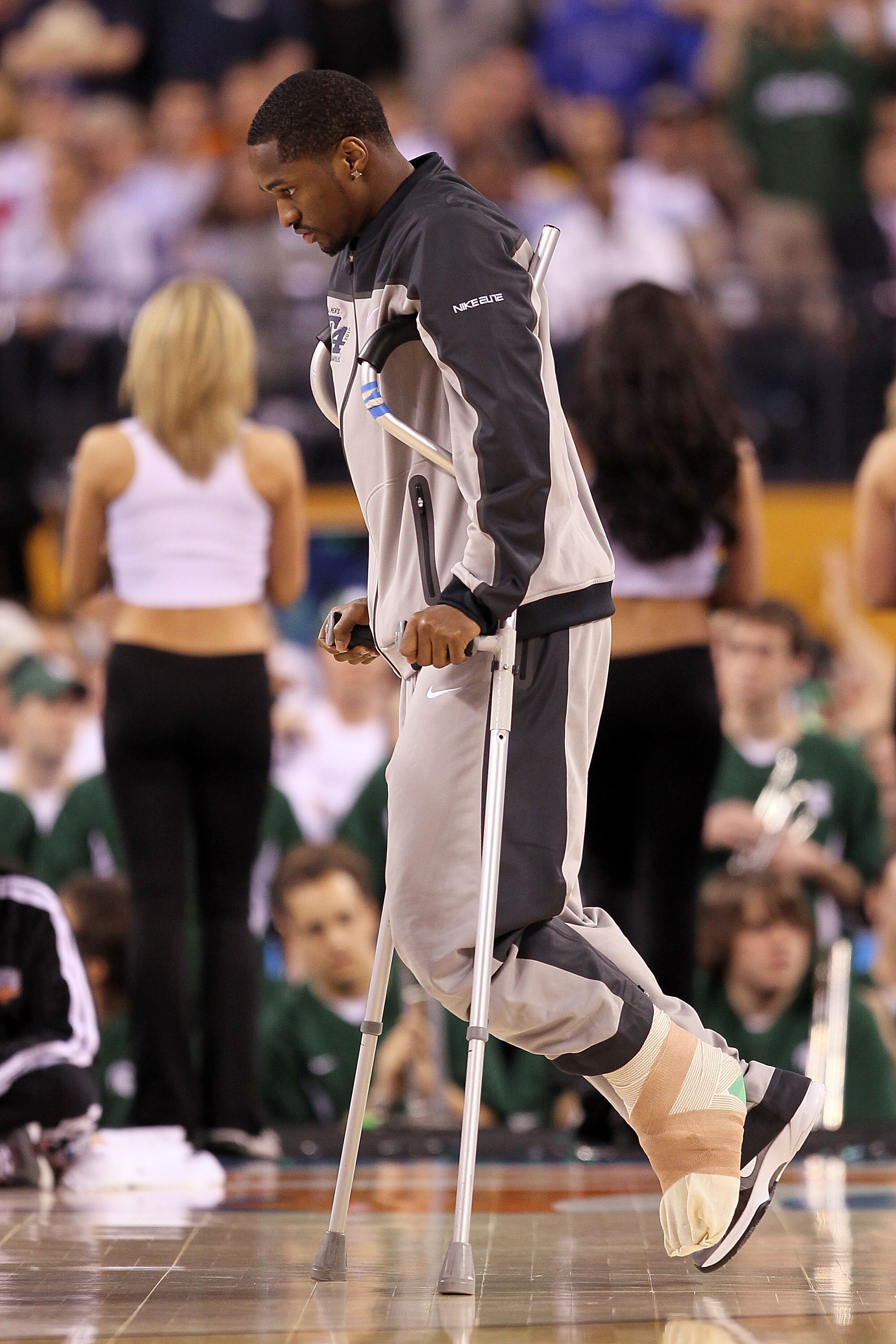 INDIANAPOLIS - APRIL 03:  Injured guard Kalin Lucas of the Michigan State Spartans arrives at the court on crutches against the Butler Bulldogs during the National Semifinal game of the 2010 NCAA Division I Men's Basketball Championship on April 3, 2010 i