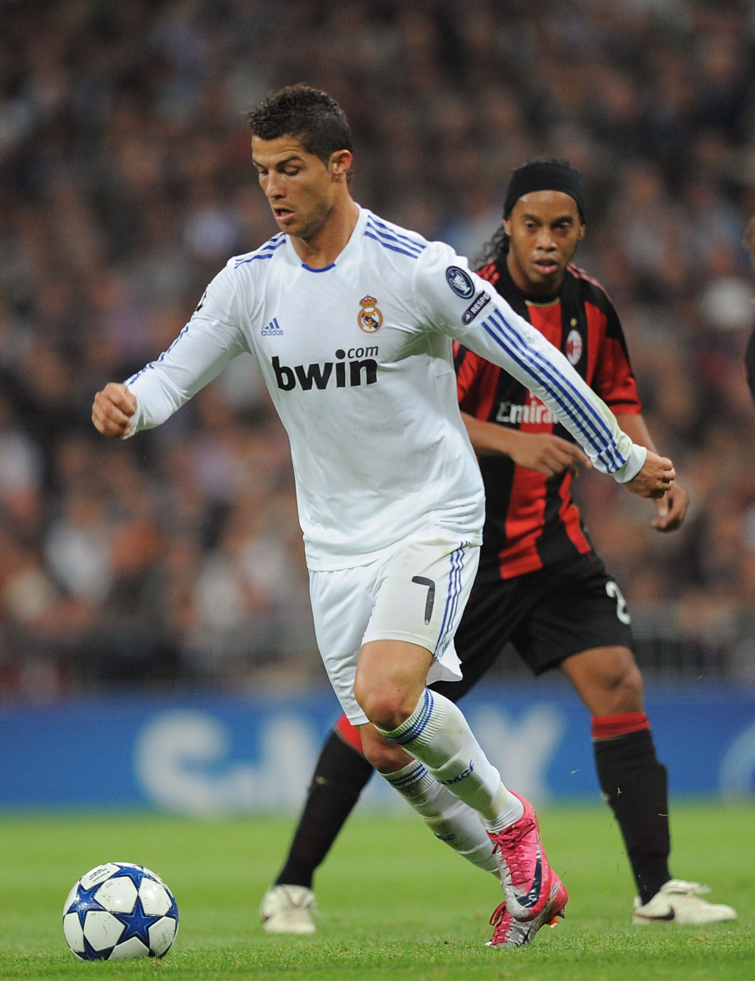 MADRID, SPAIN - OCTOBER 19:  Cristiano Ronaldo of Real Madrid dribbles with the ball while being watched by Ronaldinho of the AC Milan during the UEFA Champions League Group G match between Real Madrid and AC Milan at Estadio Santiago Bernabeu on October 