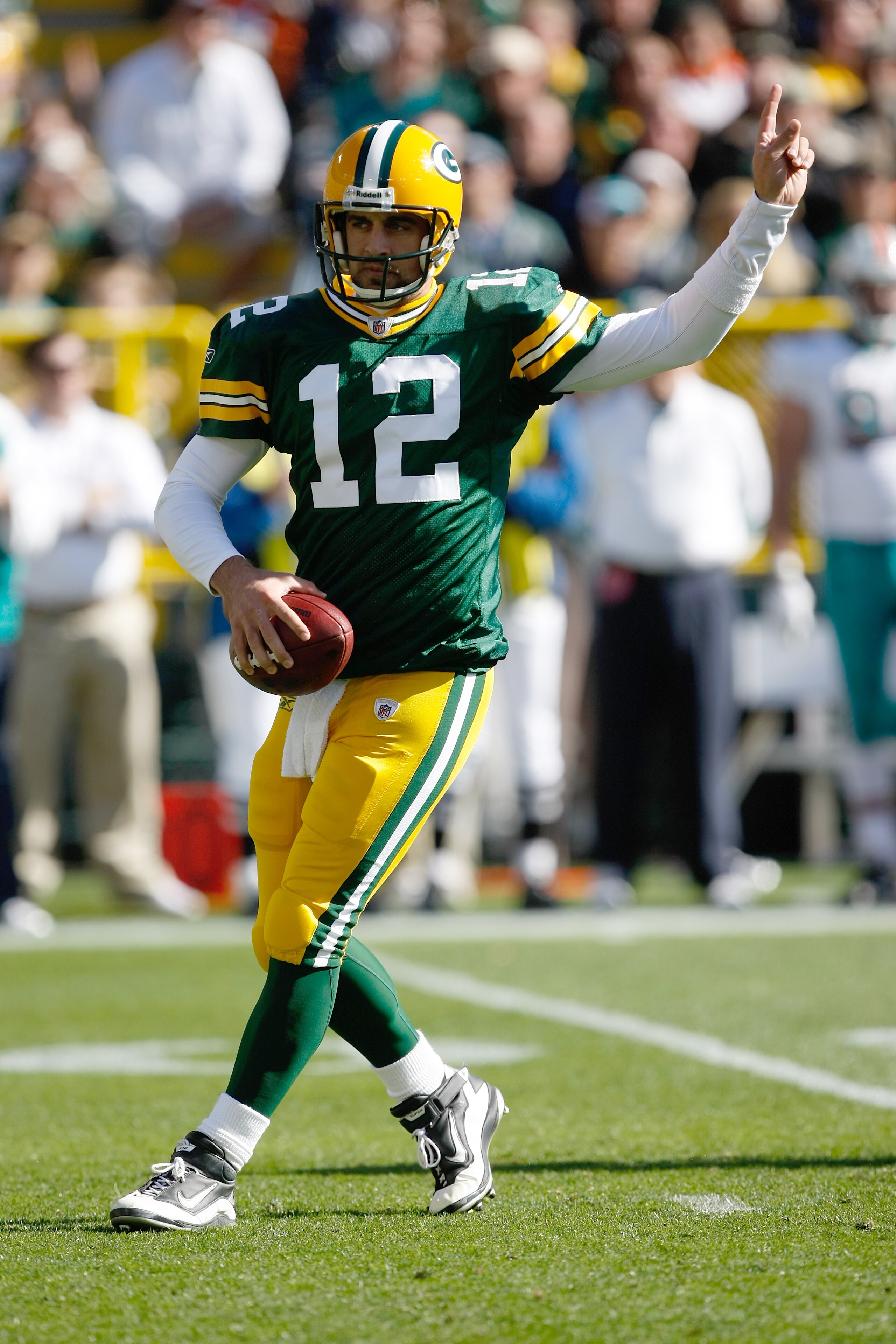 GREEN BAY, WI - OCTOBER 17: Aaron Rogers #12 of the Green Bay Packers points as he drops back to pass against the Miami Dolphins at Lambeau Field on October 17, 2010 in Green Bay, Wisconsin. (Photo by Scott Boehm/Getty Images)