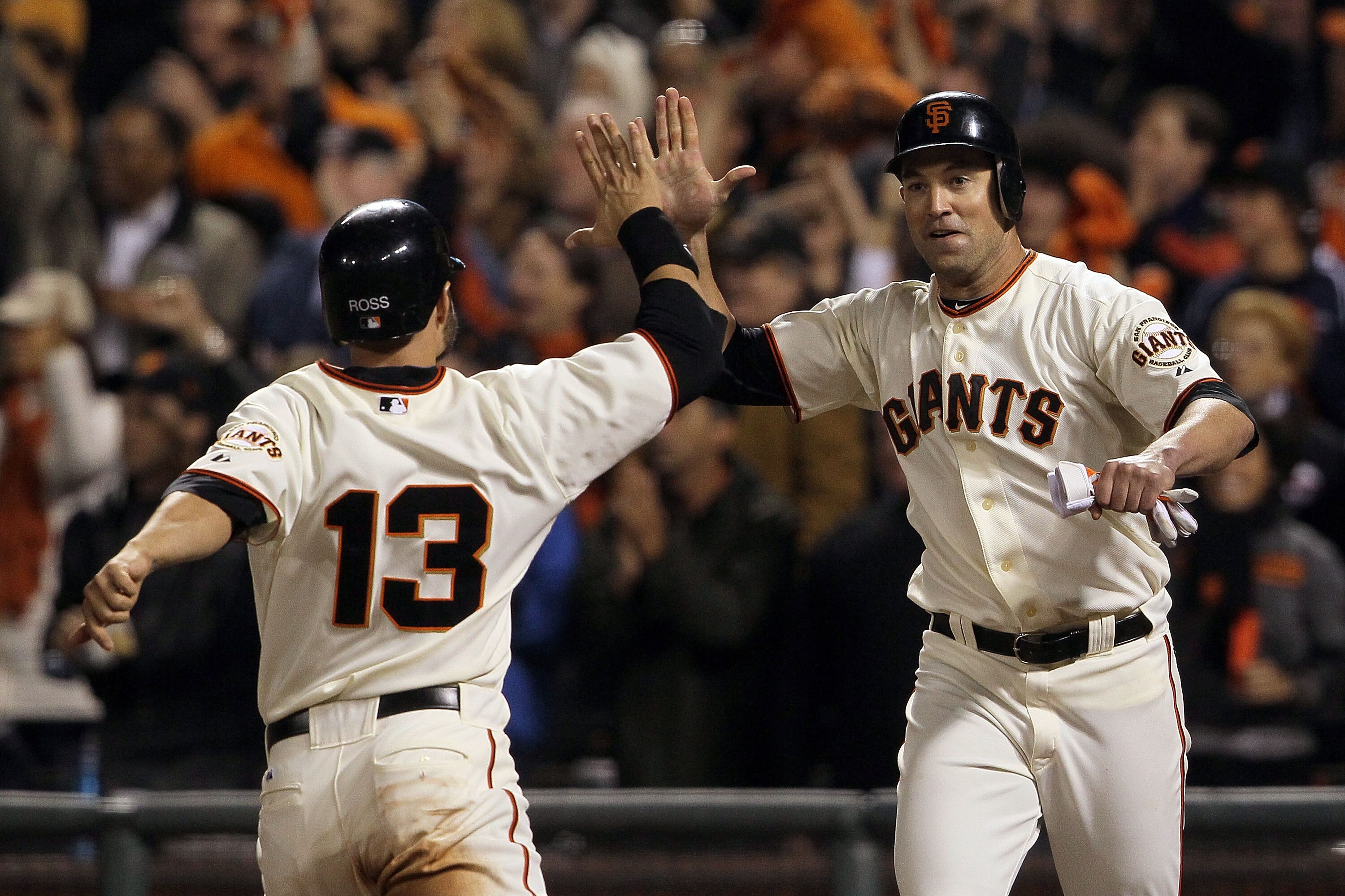 SAN FRANCISCO - OCTOBER 20: Cody Ross #13 and Pat Burrell #9 of the San Francisco Giants celebrate after scoring on a double by Pablo Sandoval #48 in the sixth inning of Game Four of the NLCS during the 2010 MLB Playoffs at AT&T Park on October 20, 2010 SAN FRANCISCO - OCTOBER 20: Cody Ross #13 and Pat Burrell #9 of the San Francisco Giants celebrate after scoring on a double by Pablo Sandoval #48 in the sixth inning of Game Four of the NLCS during the 2010 MLB Playoffs at AT&T Park on October 20, 2010