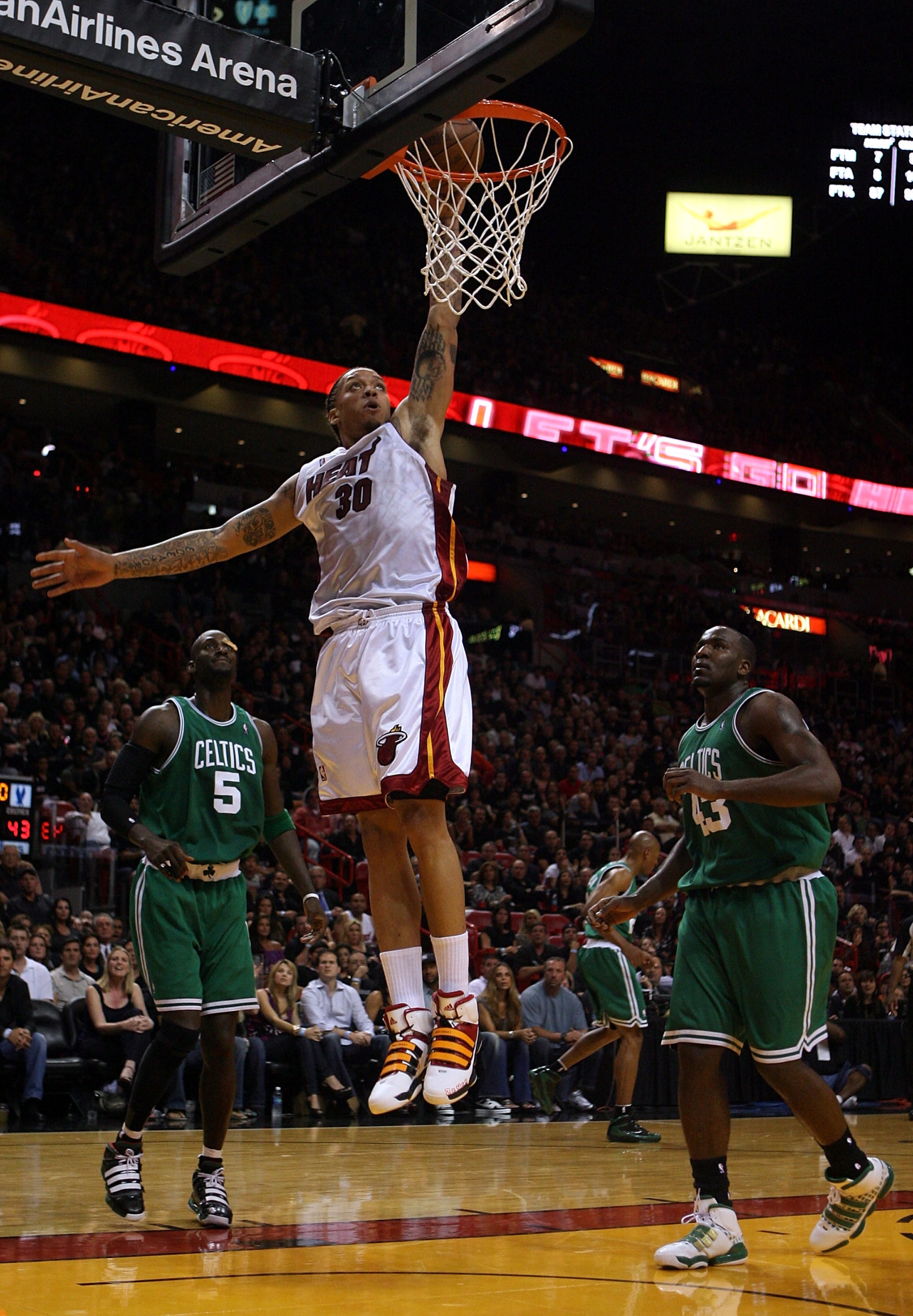 MIAMI - APRIL 23:  Forward Kevin Garnett #5 and Glen Davis #11 of the Boston Celtics defend against forward Michael Beasley #30 of the Miami Heat in Game Three of the Eastern Conference Quarterfinals during the 2010 NBA Playoffs at American Airlines Arena
