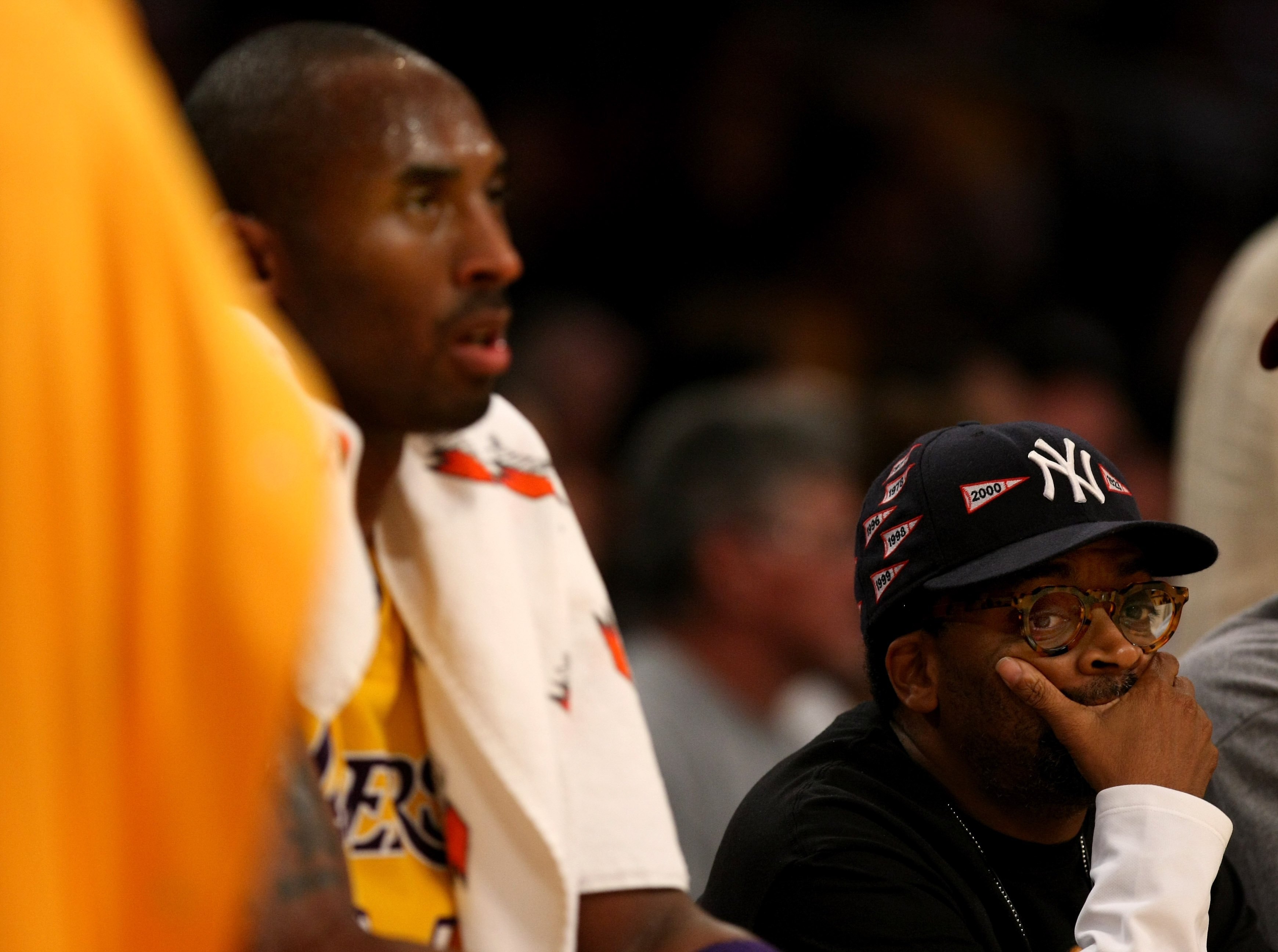 LOS ANGELES, CA - NOVEMBER 21: Director Spike Lee sits in his seat by the Laker bench as Kobe Bryant #24 of the Los Angeles Lakers rests during a time out in the game with the Denver Nuggets on November 21, 2008 at Staples Center in Los Angeles, Californi