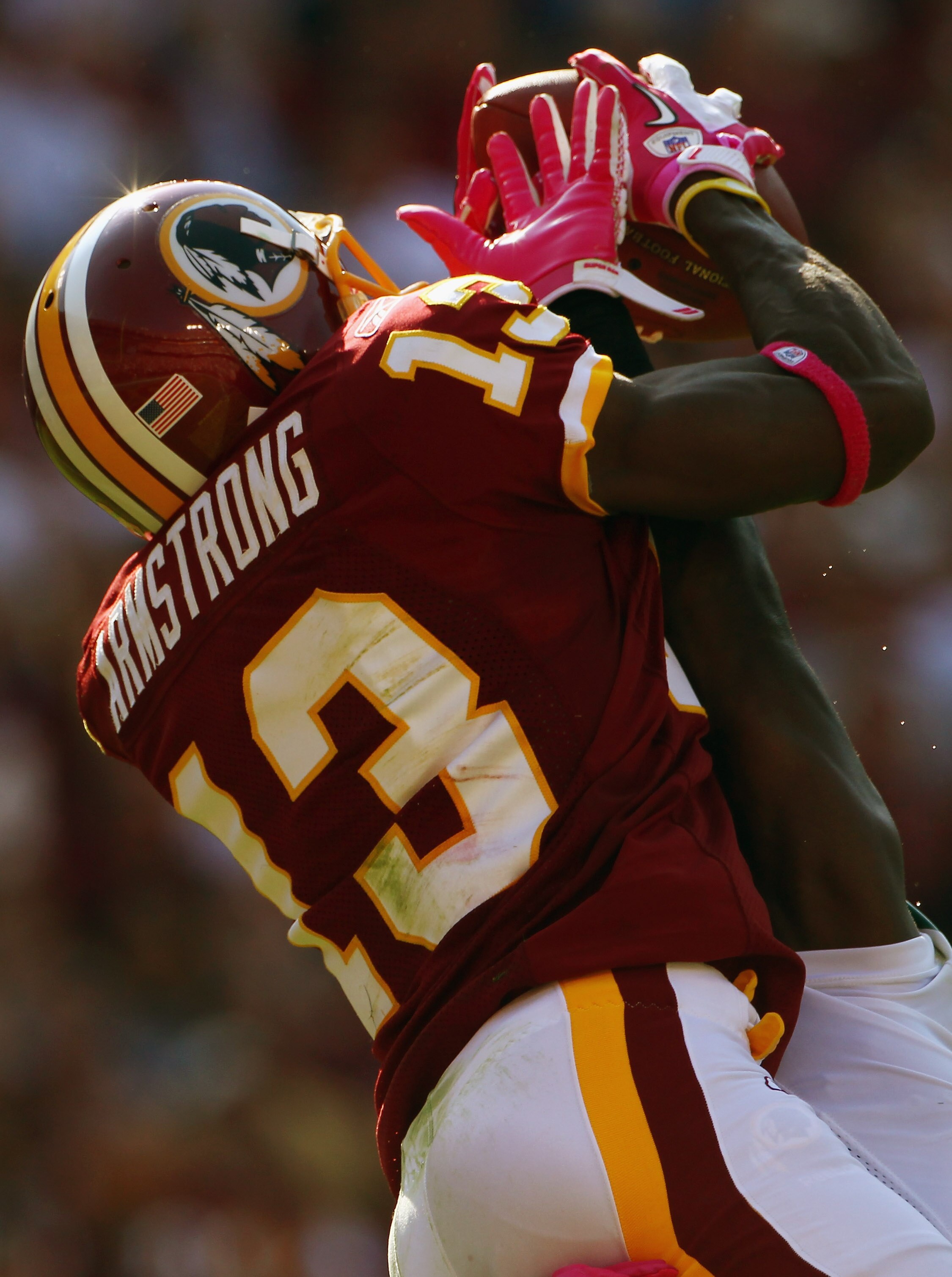 LANDOVER, MD - OCTOBER 10:  Wide receiver Anthony Armstrong #13 of the Washington Redskins catches a touchdown pass over defensive back Josh Bell #26 of the Green Bay Packers in the fourth quarter against at FedExField on October 10, 2010 in Landover, Mar