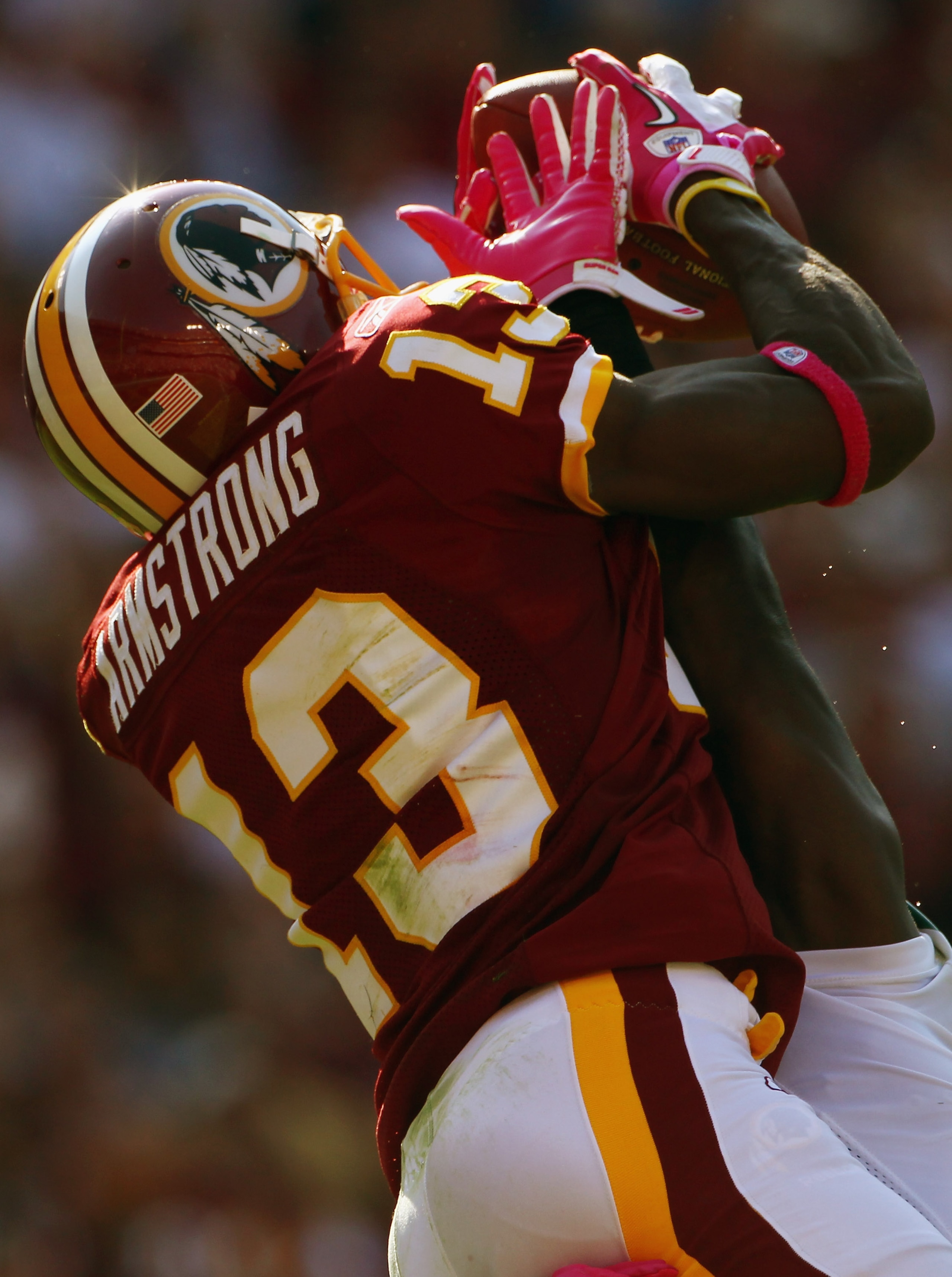 LANDOVER, MD - OCTOBER 10:  Wide receiver Anthony Armstrong #13 of the Washington Redskins catches a touchdown pass over defensive back Josh Bell #26 of the Green Bay Packers in the fourth quarter against at FedExField on October 10, 2010 in Landover, Mar