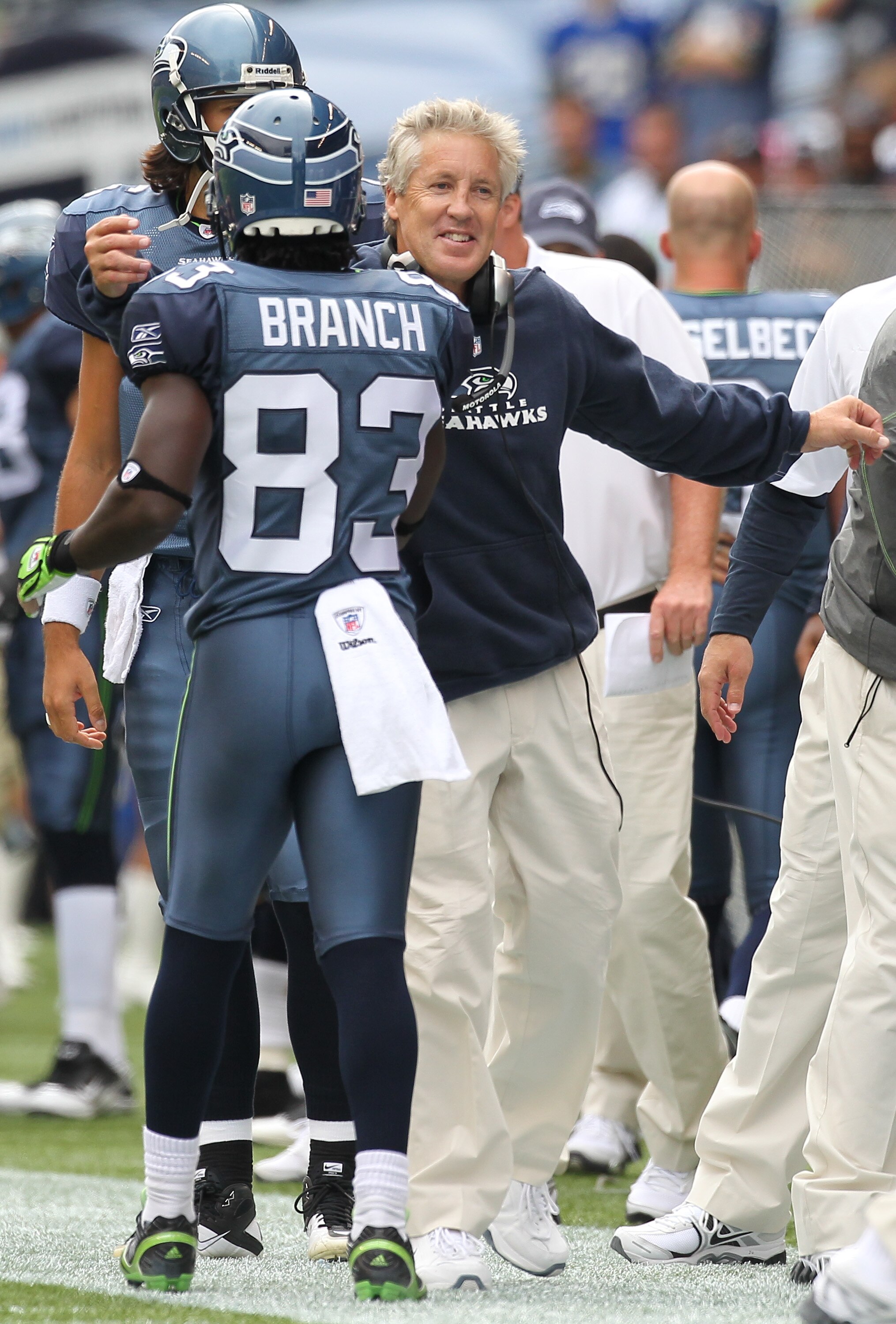 SEATTLE - SEPTEMBER 12:  Head coach Pete Carroll of the Seattle Seahawks hugs Deion Branch #83 after Deon Butler #11 scored a touchdown during the NFL season opener against the San Francisco 49ers at Qwest Field on September 12, 2010 in Seattle, Washingto