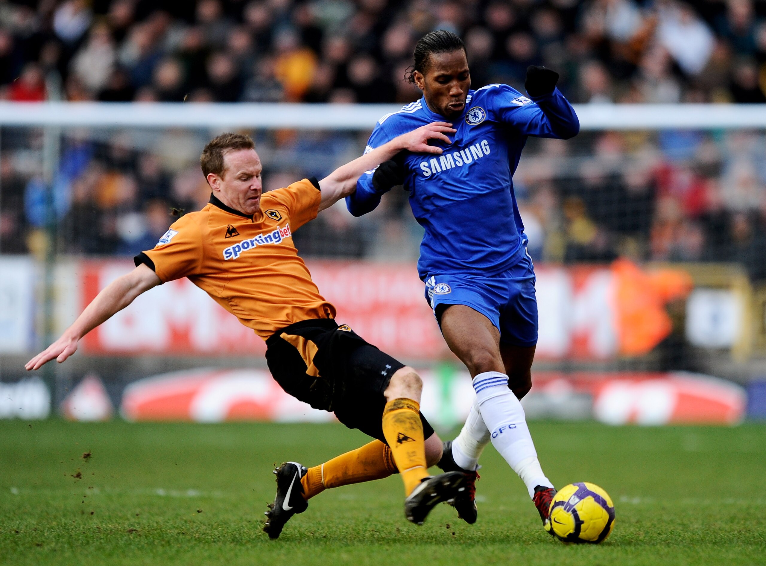 WOLVERHAMPTON, ENGLAND - FEBRUARY 20:  Jody Craddock of Wolverhampton takles Didier Drogba of Chelsea during the Barclays Premier League match between Wolverhampton Wanderers and Chelsea at Molineux on February 20, 2010 in Wolverhampton, England.  (Photo