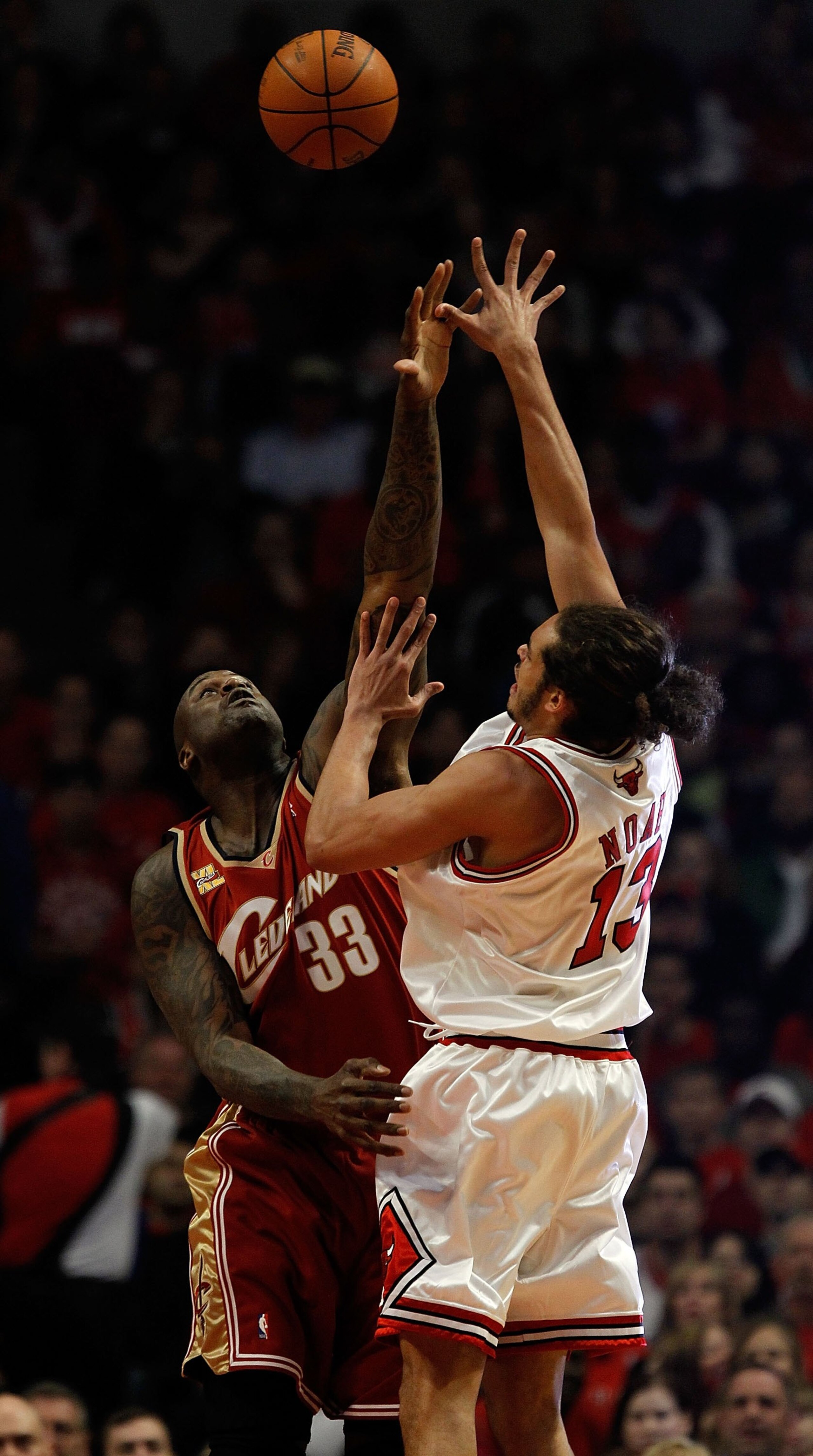 CHICAGO - APRIL 25: Joakim Noah #13 of the Chicago Bulls puts up a shot over Sahquille O'Neal #33 of the Cleveland Cavaliers in Game Four of the Eastern Conference Quarterfinals during the 2010 NBA Playoffs at the United Center on April 25, 2010 in Chicag