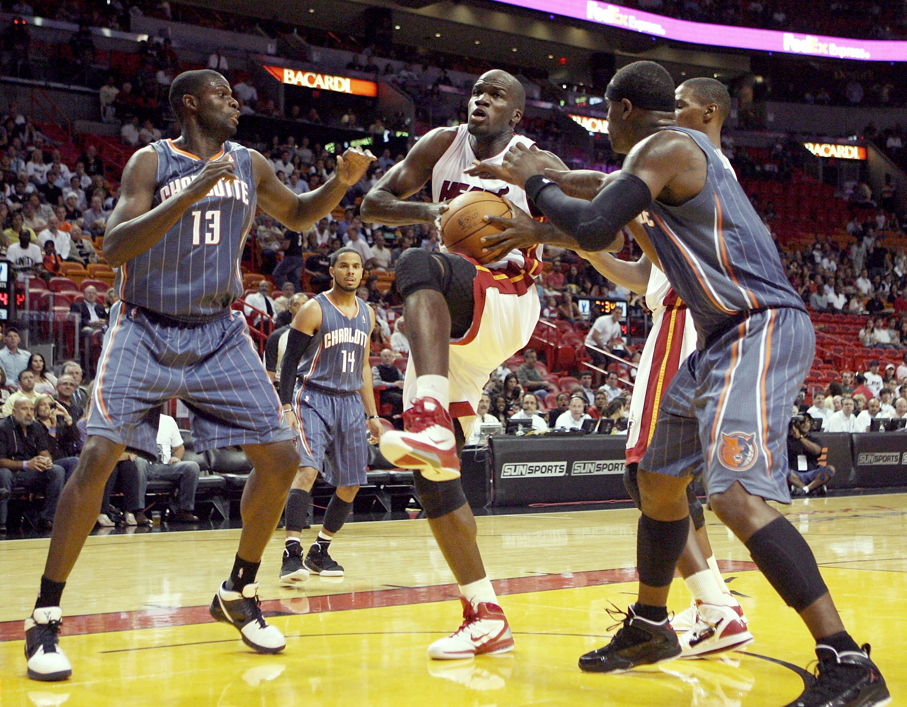 MIAMI - OCTOBER 18:  CenterJoel Anthony #50 of the Miami Heat is defended by center Nazr Mohammed #13 of the Charlotte Bobcats on October 18, 2010 at the American Airlines arena in Miami, Florida.  NOTE TO USER: User expressly acknowledges and agrees that