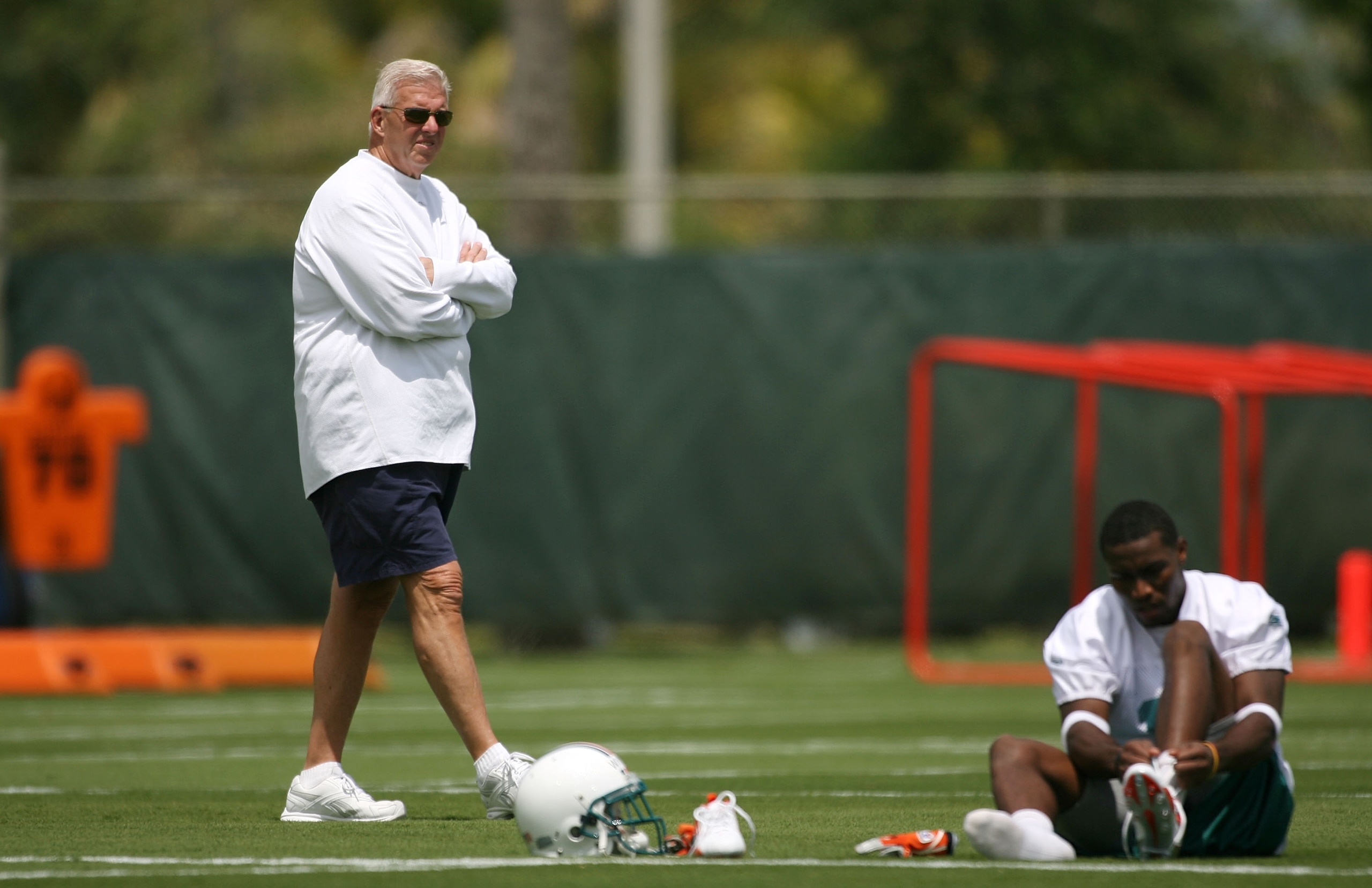 DAVIE, FL - MAY 02:  Executive Vice President of Football Operations Bill Parcells (L) walks past a player at practice on during Miami Dolphins Rookie Mini Camp on May 2, 2008 at the Dolphins practice facility in Davie, Florida.  (Photo by Marc Serota/Get