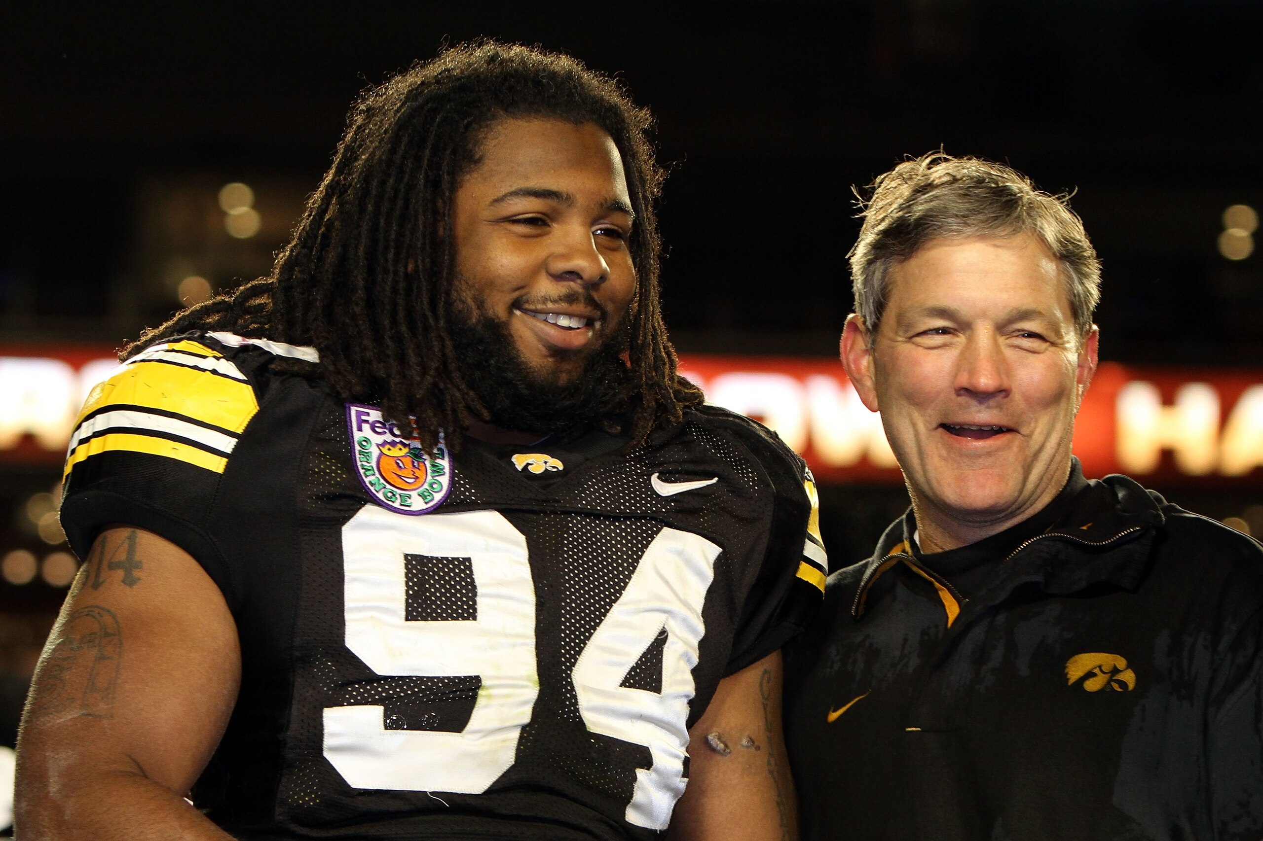 MIAMI GARDENS, FL - JANUARY 05:  Andrian Clayborn #94 and head coach Kirk Ferentz of the Iowa Hawkeyes celebrate after Iowa won 24-14 against the Georgia Tech Yellow Jackets during the FedEx Orange Bowl at Land Shark Stadium on January 5, 2010 in Miami Ga
