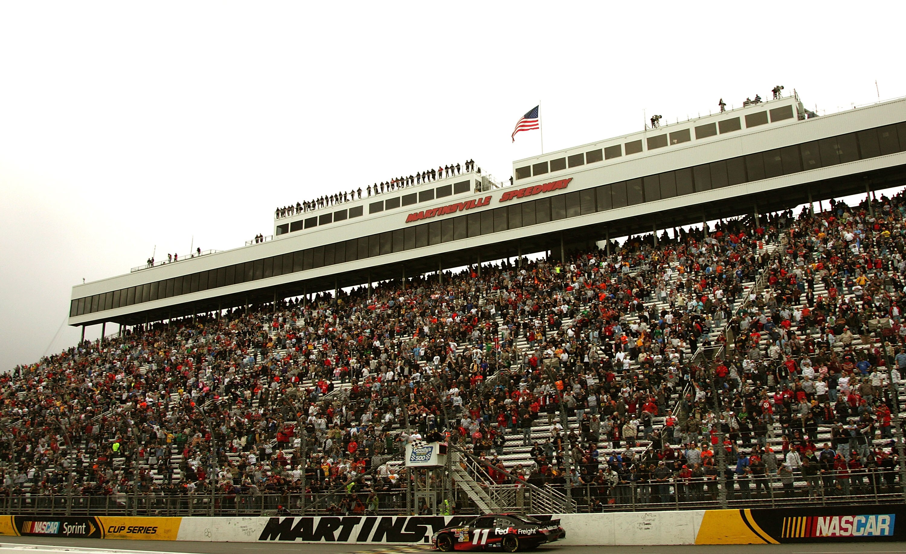 MARTINSVILLE, VA - MARCH 29:  Denny Hamlin, driver ofthe #11 FedEx Freight Toyota takes the checkered flag, winning the NASCAR Sprint Cup Series Goody's Fast Pain Relief 500 at Martinsville Speedway on March 29, 2010 in Martinsville, Virginia.  (Photo by