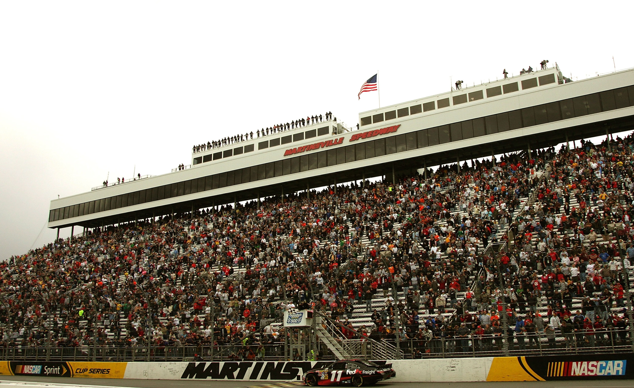 MARTINSVILLE, VA - MARCH 29:  Denny Hamlin, driver ofthe #11 FedEx Freight Toyota takes the checkered flag, winning the NASCAR Sprint Cup Series Goody's Fast Pain Relief 500 at Martinsville Speedway on March 29, 2010 in Martinsville, Virginia.  (Photo by