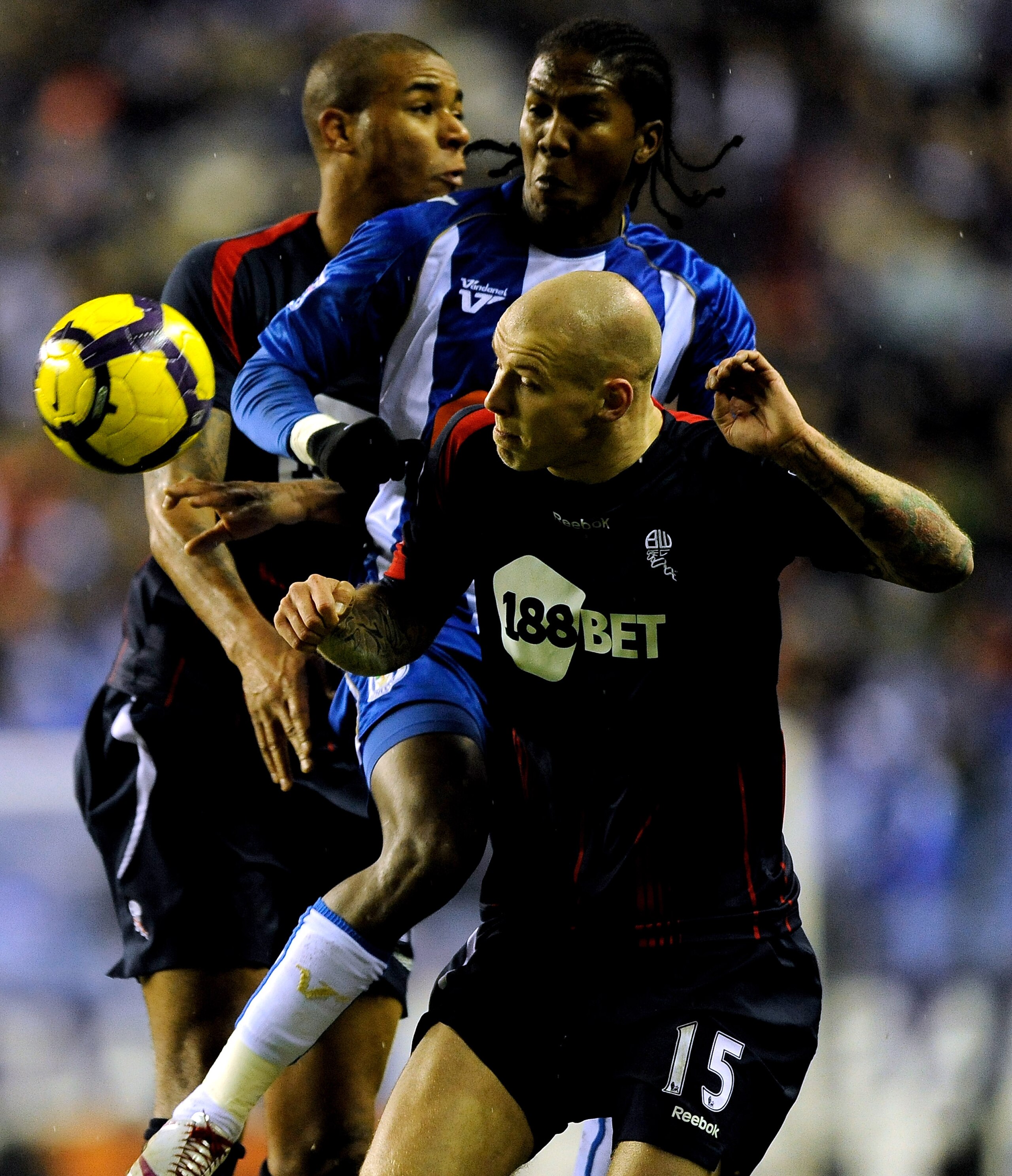 WIGAN, ENGLAND - FEBRUARY 17: Hugo Rodallega of Wigan battles with Gretar Steinsson and Zat Knight of Bolton during the Barclays Premier League Match between Wigan Athletic and Bolton Wanderers at DW Stadium on February 17, 2010 in Wigan, England.  (Photo