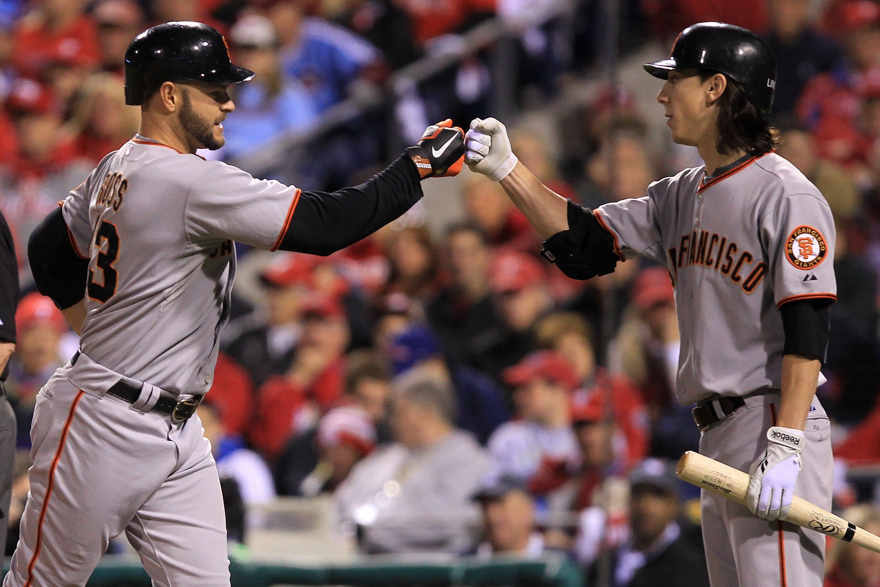 PHILADELPHIA - OCTOBER 16:  Cody Ross #13 of the San Francisco Giants is greeted at home by pitcher Tim Lincecum #55 after Ross hit a fifth inning home run against the Philadelphia Phillies in Game One of the NLCS during the 2010 MLB Playoffs at Citizens