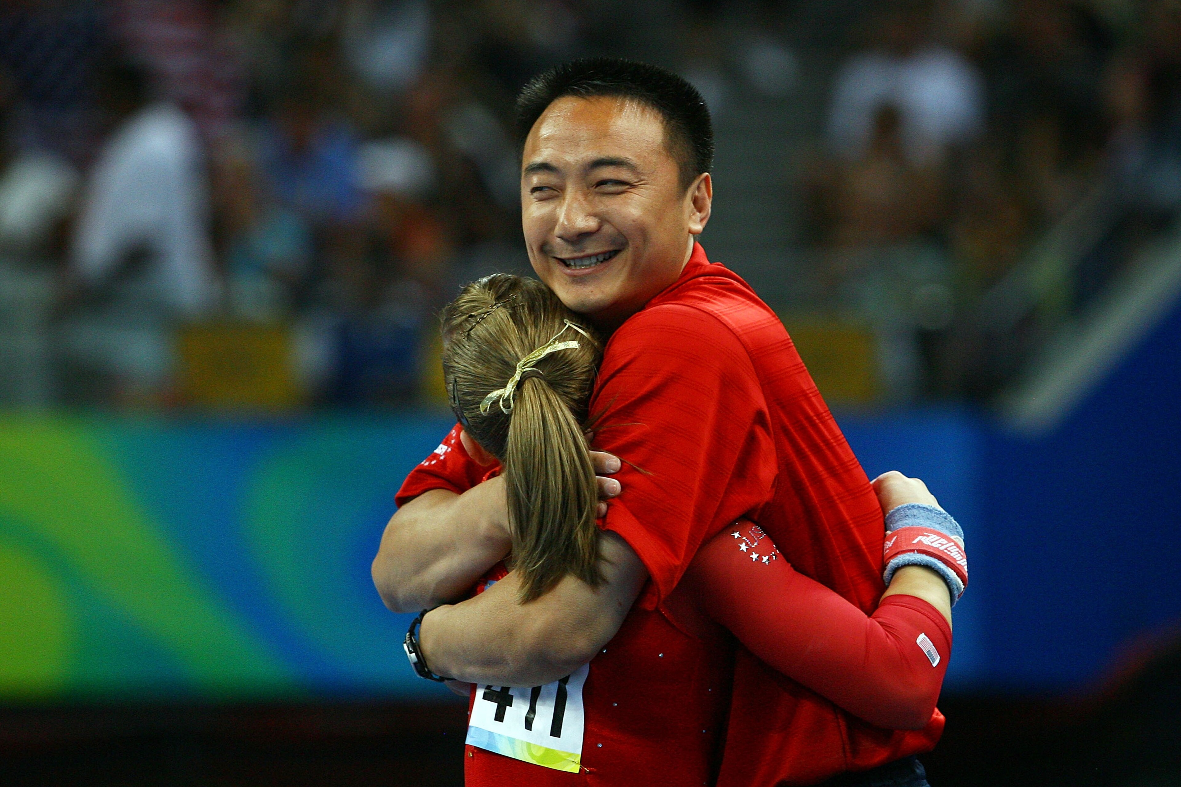 BEIJING - AUGUST 15:  Shawn Johnson of the United States hugs her coach Liang Chow after her routine on the uneven bars during the artistic gymnastics event at the National Indoor Stadium on Day 7 of the Beijing 2008 Olympic Games on August 15, 2008 in Be