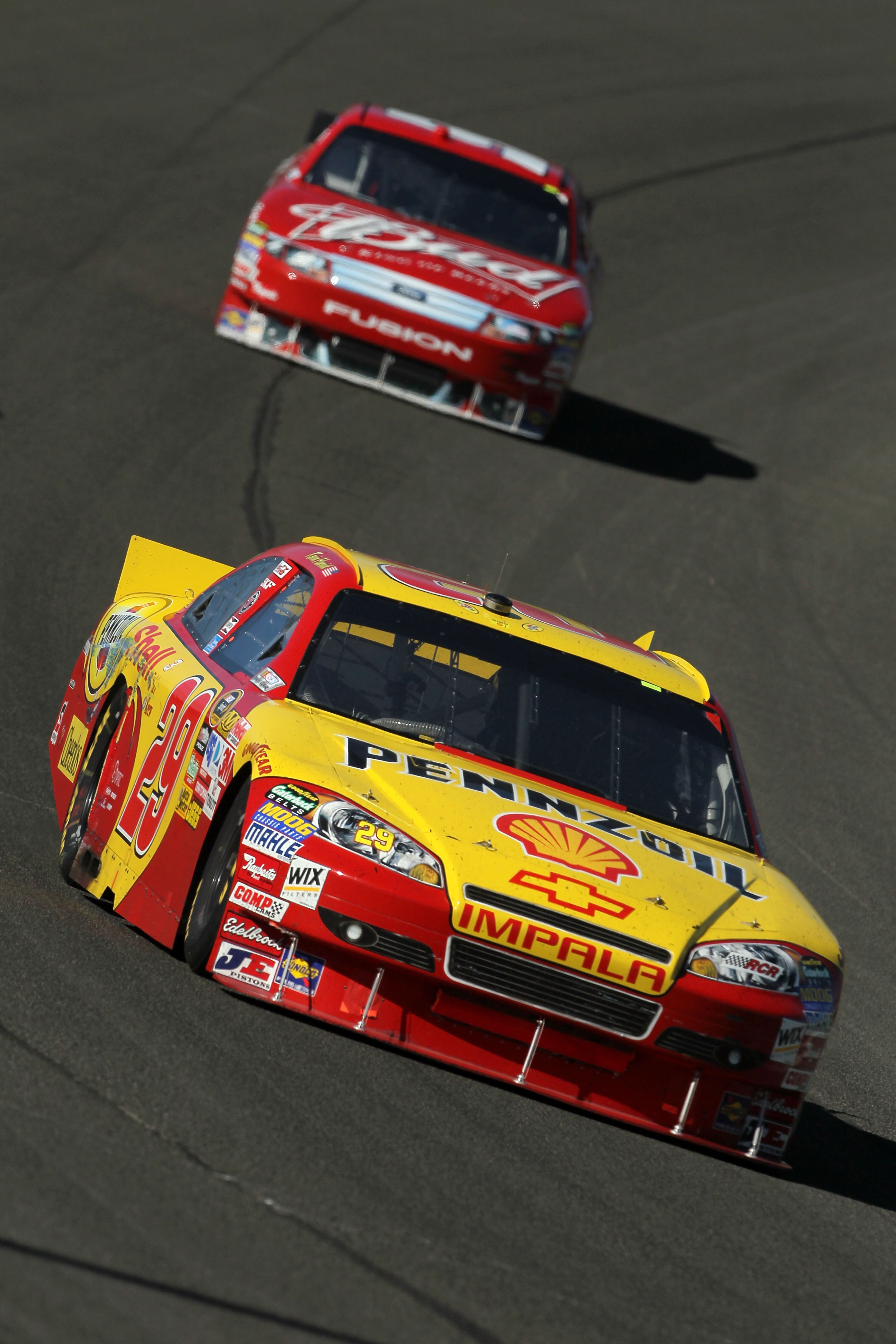 FONTANA, CA - OCTOBER 10:  Kevin Harvick, driver of the #29 Shell/Pennzoil Chevrolet, leads Kasey Kahne, driver of the #9 Budweiser Ford, during the NASCAR Sprint Cup Series Pepsi Max 400 on October 10, 2010 in Fontana, California.  (Photo by Jeff Gross/G