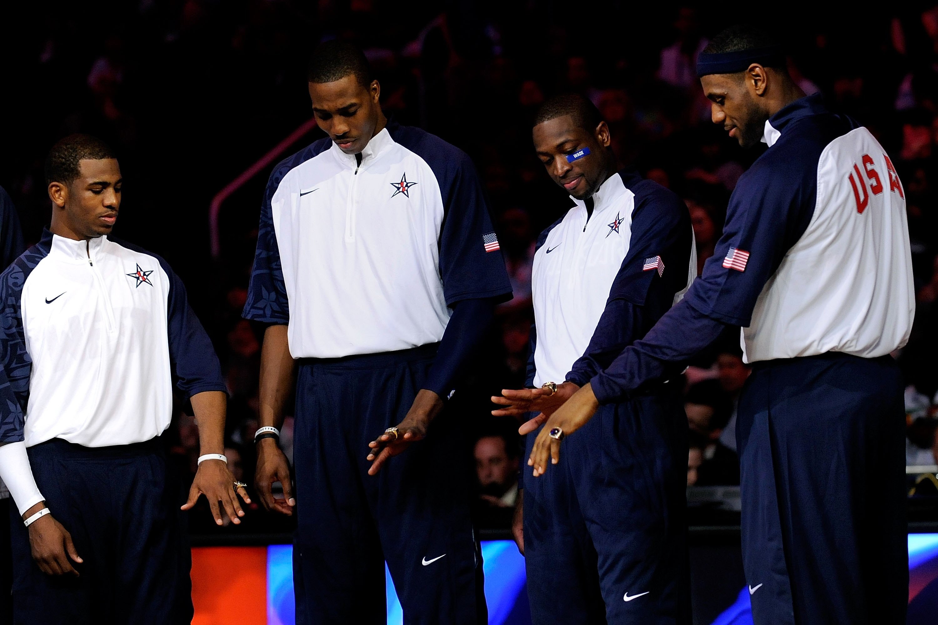 PHOENIX - FEBRUARY 15:  (L-R) Chris Paul, Dwight Howard, Dwyane Wade and LeBron James, members of the gold medal winning USA Olympic basketball team, admire their rings during half time of the 58th NBA All-Star Game, part of 2009 NBA All-Star Weekend at U