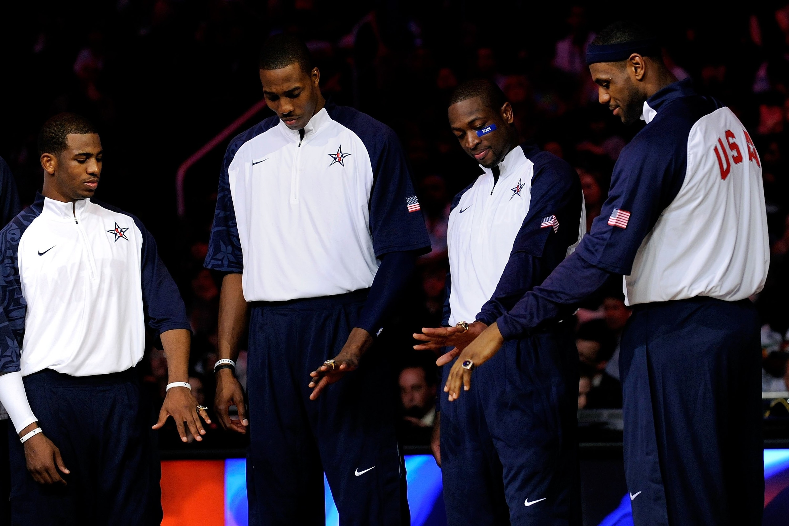 PHOENIX - FEBRUARY 15:  (L-R) Chris Paul, Dwight Howard, Dwyane Wade and LeBron James, members of the gold medal winning USA Olympic basketball team, admire their rings during half time of the 58th NBA All-Star Game, part of 2009 NBA All-Star Weekend at U