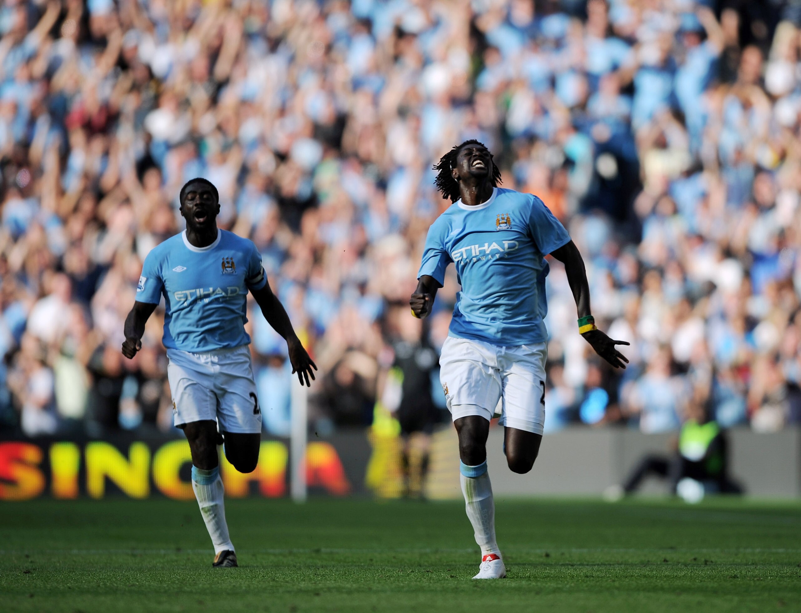 MANCHESTER, ENGLAND - SEPTEMBER 12:  Emmanuel Adebayor of Manchester City celebrates with team-mate Kolo Toure after scoring during the Barclays Premier League match between Manchester City and Arsenal at the City of Manchester Stadium on September 12, 20