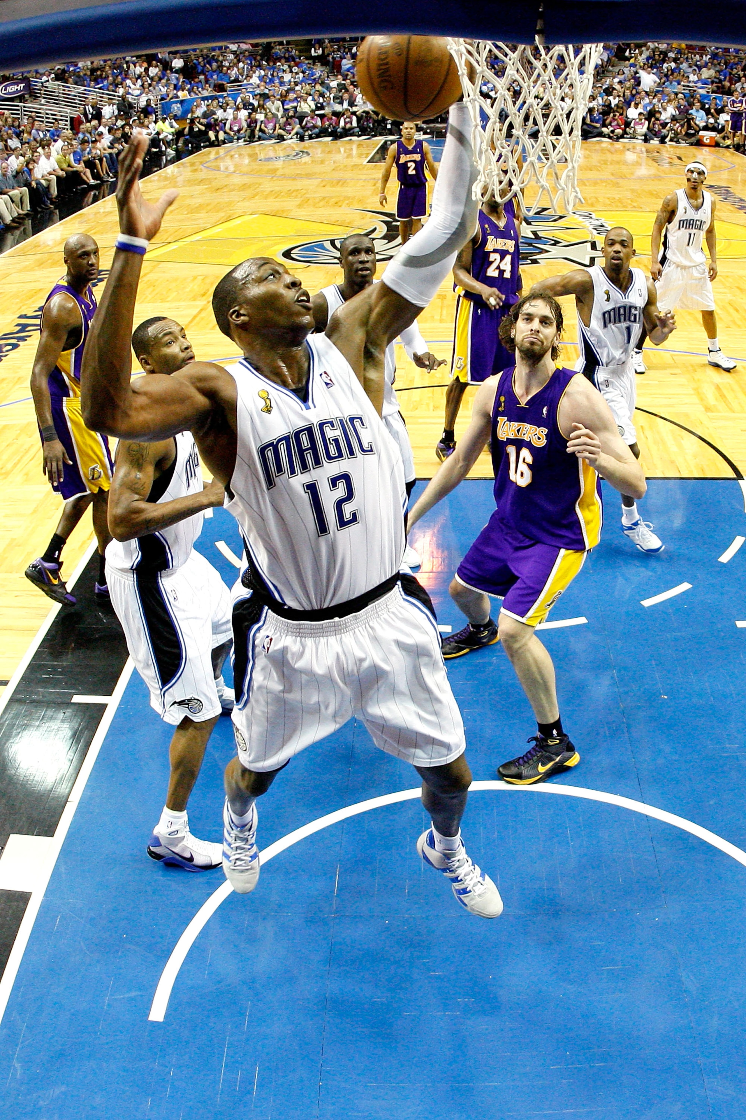 ORLANDO, FL - JUNE 09:  Dwight Howard #12 of the Orlando Magic grabs a rebound in Game Three of the 2009 NBA Finals against the Los Angeles Lakers on June 9, 2009 at Amway Arena in Orlando, Florida.  NOTE TO USER:  User expressly acknowledges and agrees t