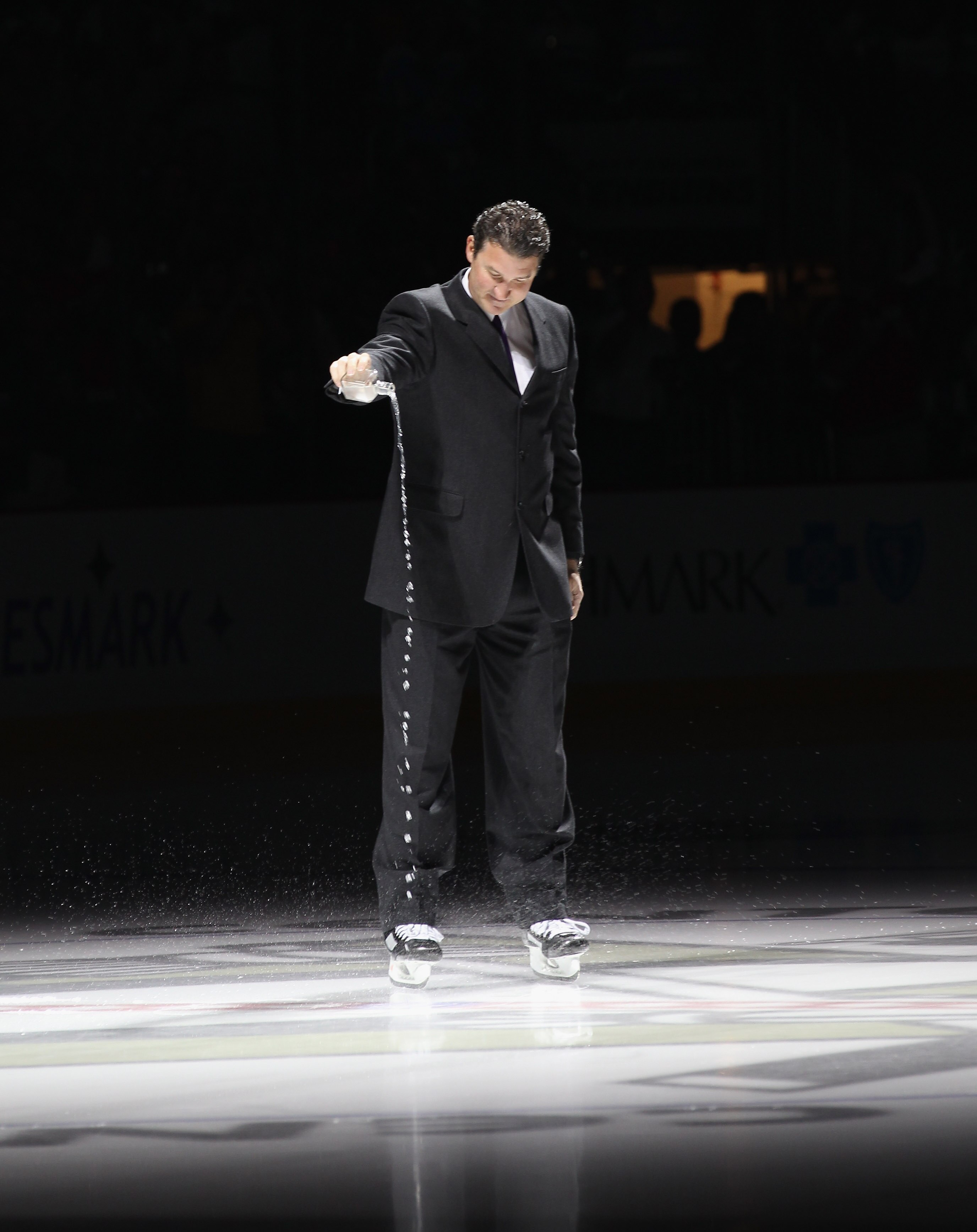 PITTSBURGH - OCTOBER 07:  Team owner Mario Lemieux of the Pittsburgh Penguins accompanied with water from the Mellon Arena salutes the crowd prior to the arena opening game against the Philadelphia Flyers at the Consol Energy Center on October 7, 2010 in