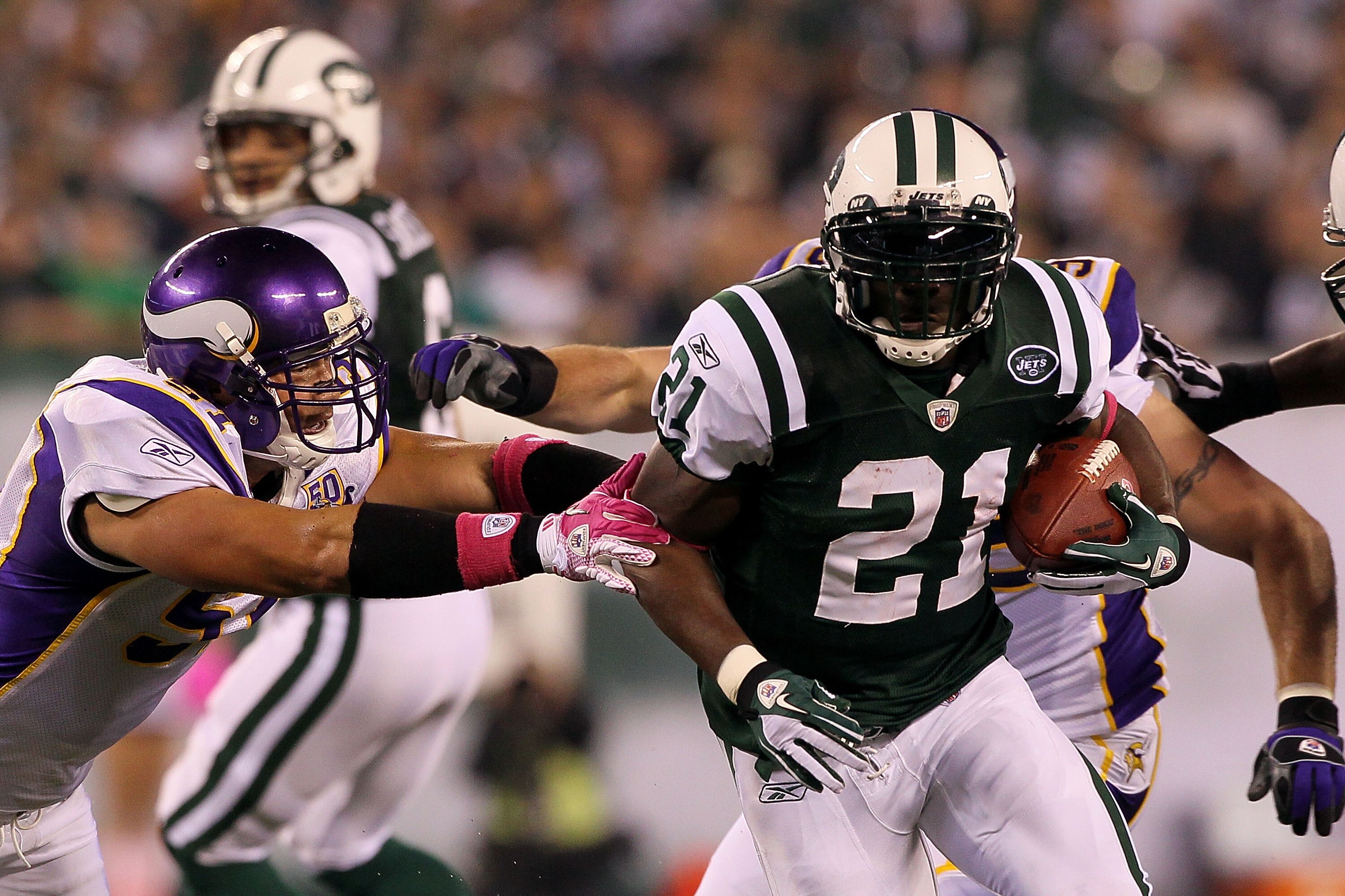 EAST RUTHERFORD, NJ - OCTOBER 11:  LaDainian Tomlinson #21 of the New York Jets runs the ball in the first half against Ben Leber #51 of the Minnesota Vikings at New Meadowlands Stadium on October 11, 2010 in East Rutherford, New Jersey.  (Photo by Jim Mc