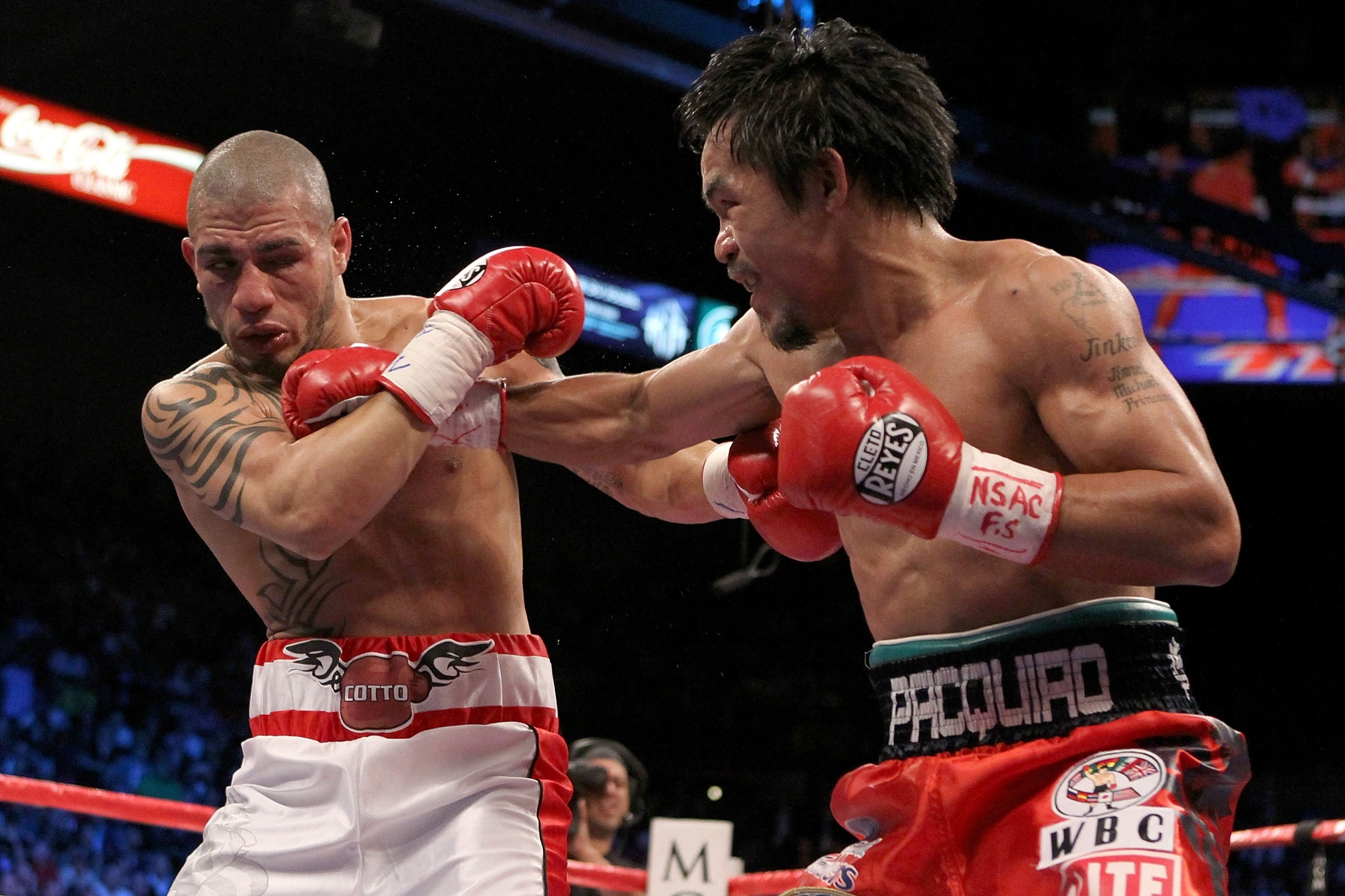 LAS VEGAS - NOVEMBER 14:  (R-L) Manny Pacquiao throws a right to the head of Miguel Cotto during their WBO welterweight title fight at the MGM Grand Garden Arena on November 14, 2009 in Las Vegas, Nevada.  (Photo by Al Bello/Getty Images)