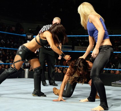 LayCool double-teaming an opponent, photo copyright to WWE.com