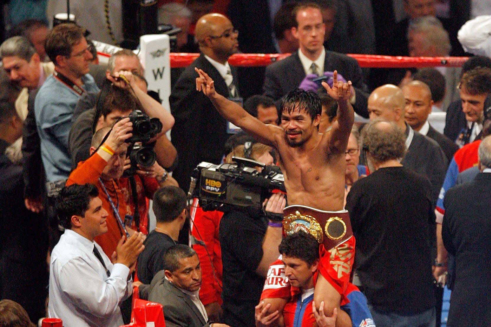 ARLINGTON, TX - MARCH 13:  Manny Pacquiao of the Philippines celebrates in the ring after defeating Joshua Clottey of Ghana during the WBO welterweight title fight at Cowboys Stadium on March 13, 2010 in Arlington, Texas. Pacquiao defeated Clottey by unan