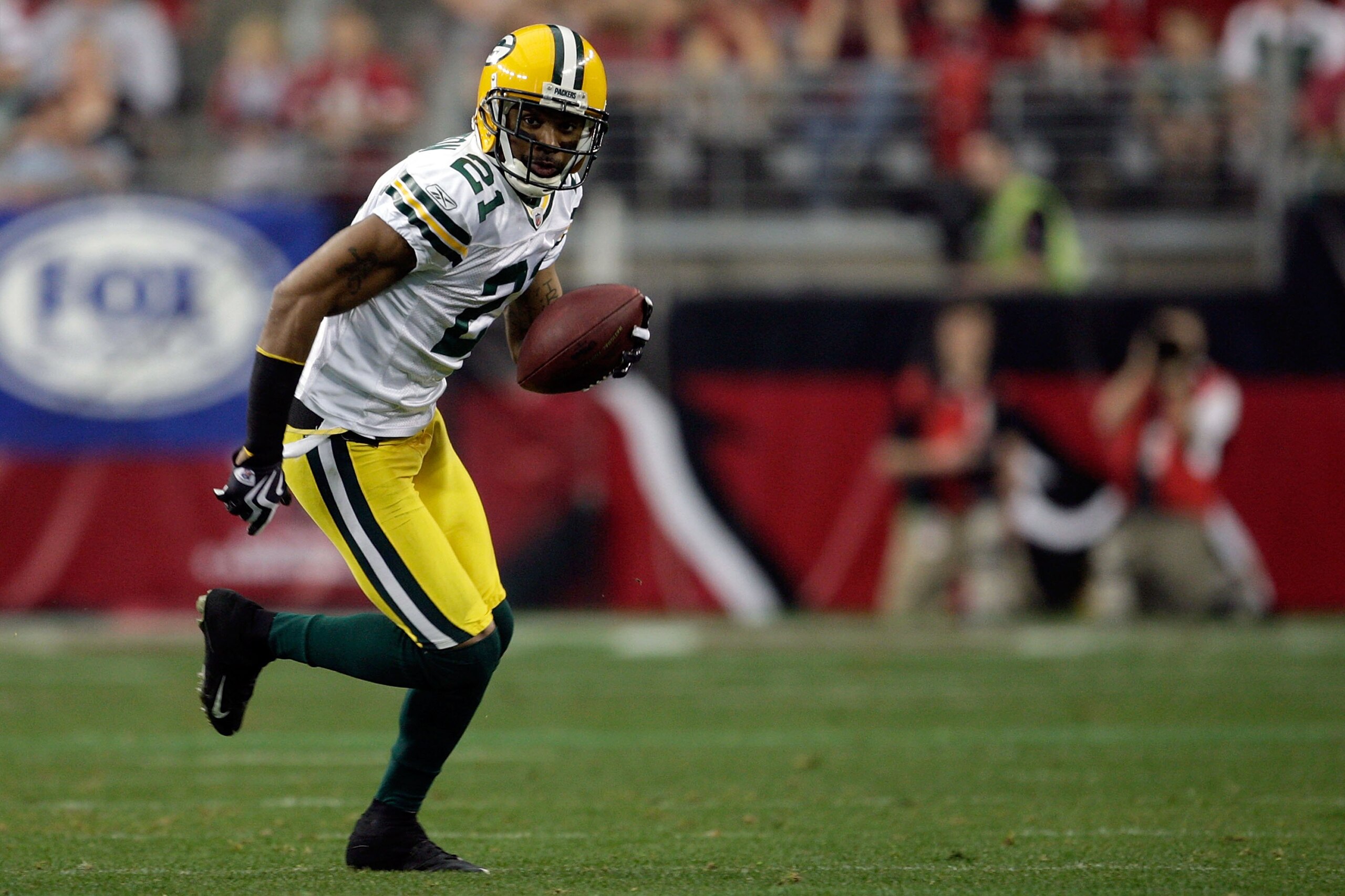GLENDALE, AZ - JANUARY 03:  Charles Woodson #21 of the Green Bay Packers runs for a 45-yard interception return for a touchdown against the Arizona Cardinals in the second quarter at University of Phoenix Stadium on January 3, 2010 in Glendale, Arizona.  