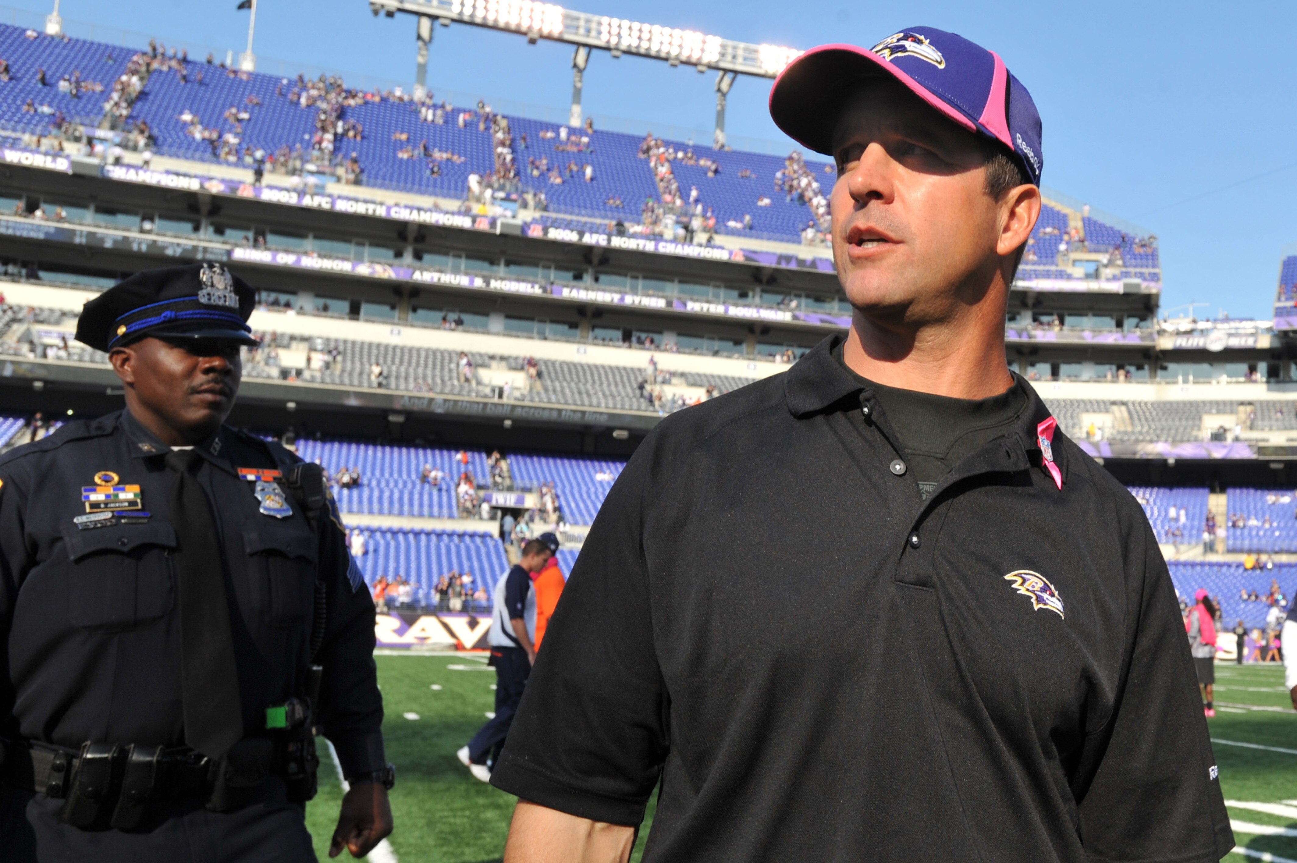 BALTIMORE, MD - OCTOBER 10: Head coach John Harbaugh of the Baltimore Ravens walks off the field after the game against the Denver Broncos at M&T Bank Stadium on October 10, 2010 in Baltimore, Maryland. Players wore pink in recognition of Breast Cancer Aw