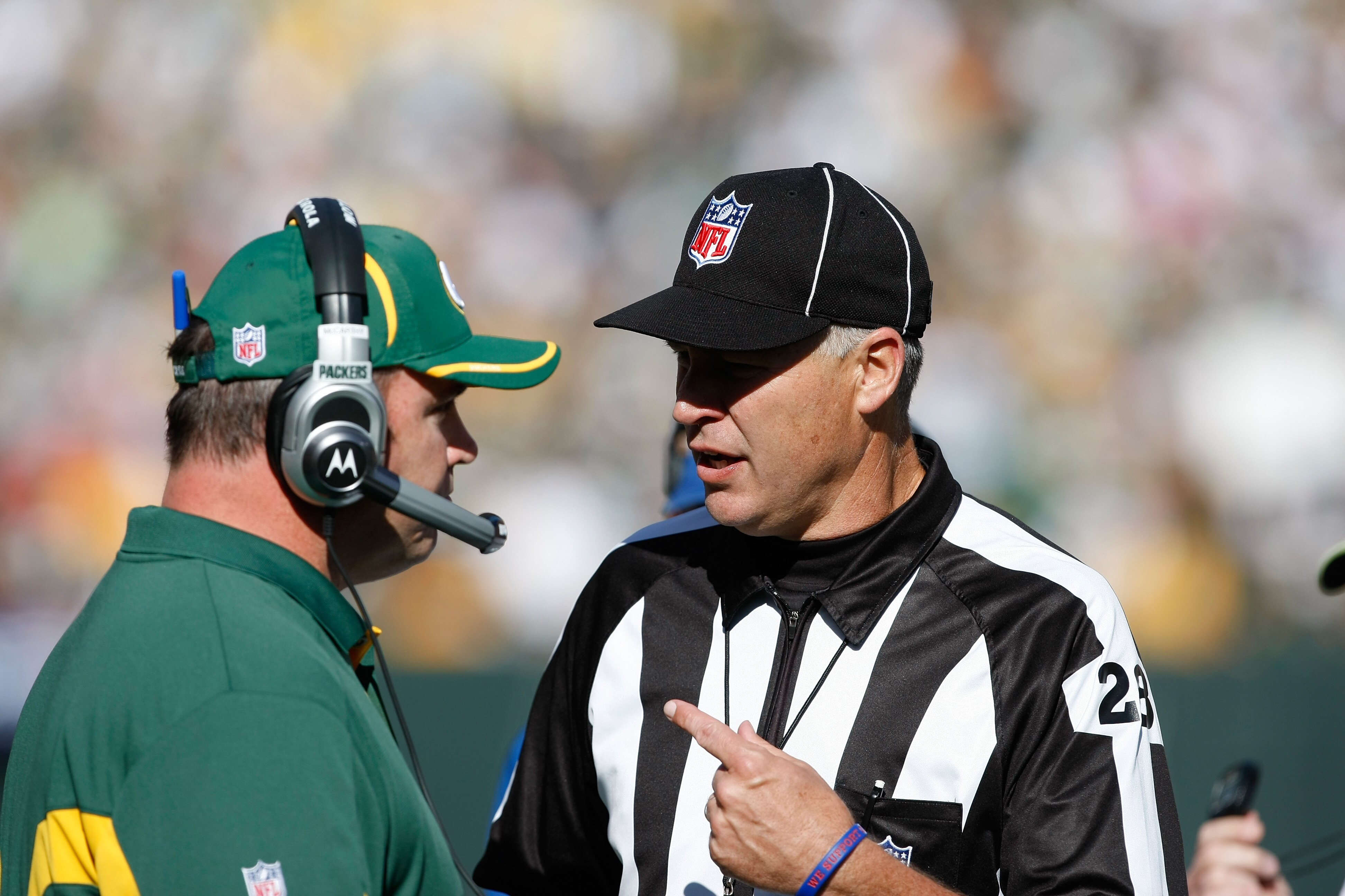 GREEN BAY, WI - OCTOBER 17: Mike McCarthy of the Green Bay Packers talks with Mark Hittner #28 against the Miami Dolphins at Lambeau Field on October 17, 2010 in Green Bay, Wisconsin. The Dolphins defeated the Packers 23-20 in overtime. (Photo by Scott Bo