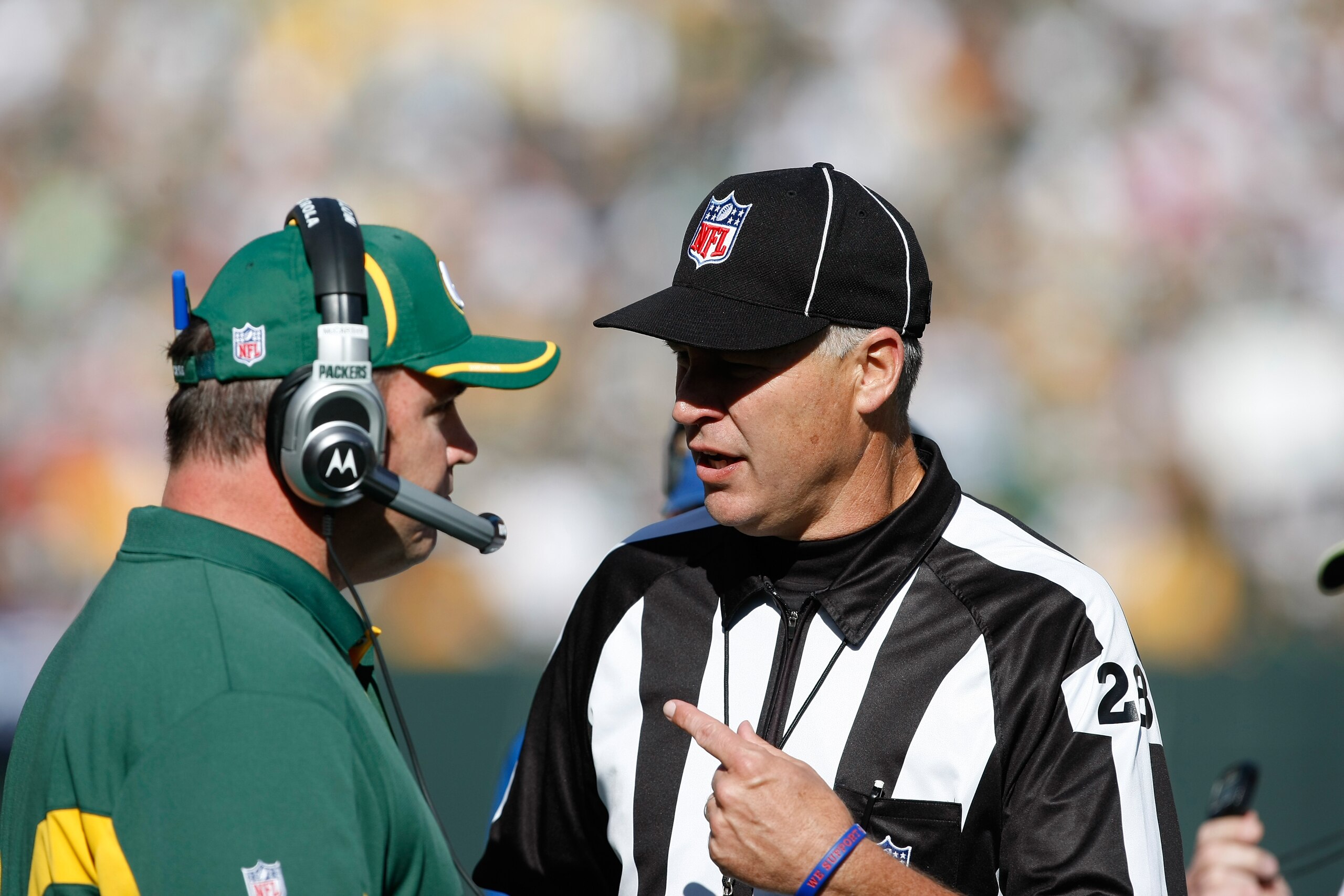 GREEN BAY, WI - OCTOBER 17: Mike McCarthy of the Green Bay Packers talks with Mark Hittner #28 against the Miami Dolphins at Lambeau Field on October 17, 2010 in Green Bay, Wisconsin. The Dolphins defeated the Packers 23-20 in overtime. (Photo by Scott Bo