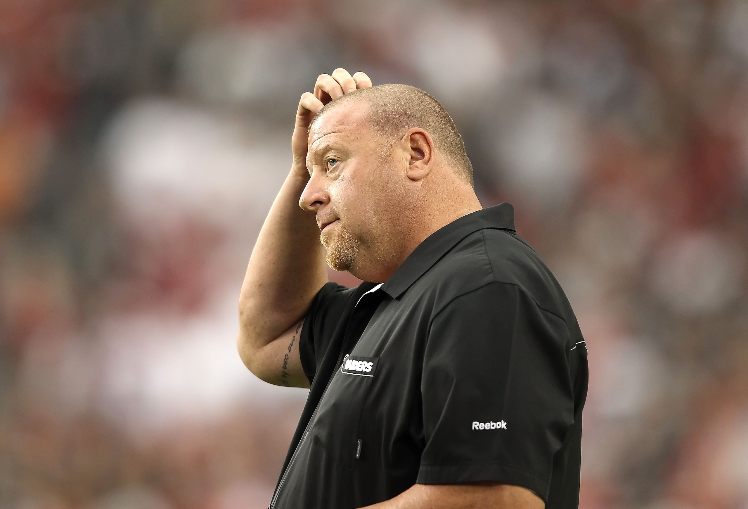 GLENDALE, AZ - SEPTEMBER 26:  Head coach Tom Cable of the Oakland Raiders stands on the sidelines during the NFL game against the Arizona Cardinals at the University of Phoenix Stadium on September 26, 2010 in Glendale, Arizona.  The Cardinals defeated th