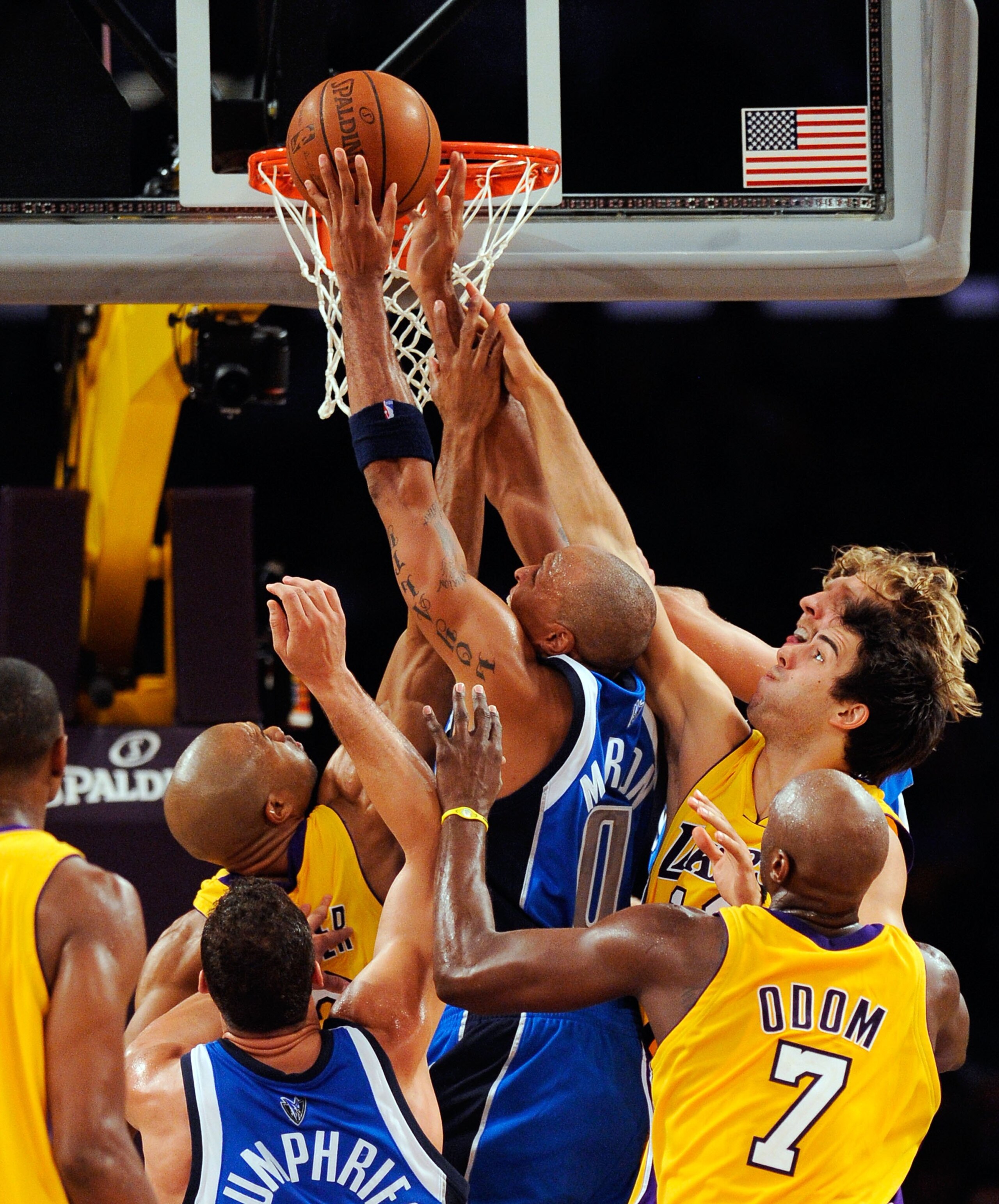 LOS ANGELES, CA - OCTOBER 30:  Shawn Marion #0 (C) of the Dallas Mavericks pulls down a rebound as teammates Dirk Nowitzki #41,(L)  Kris Humphries #43 (2R) look on against Derek Fisher #2 (R), Sasha Vujacic #18 (RL) and Lamar Odom of the Los Angeles Laker