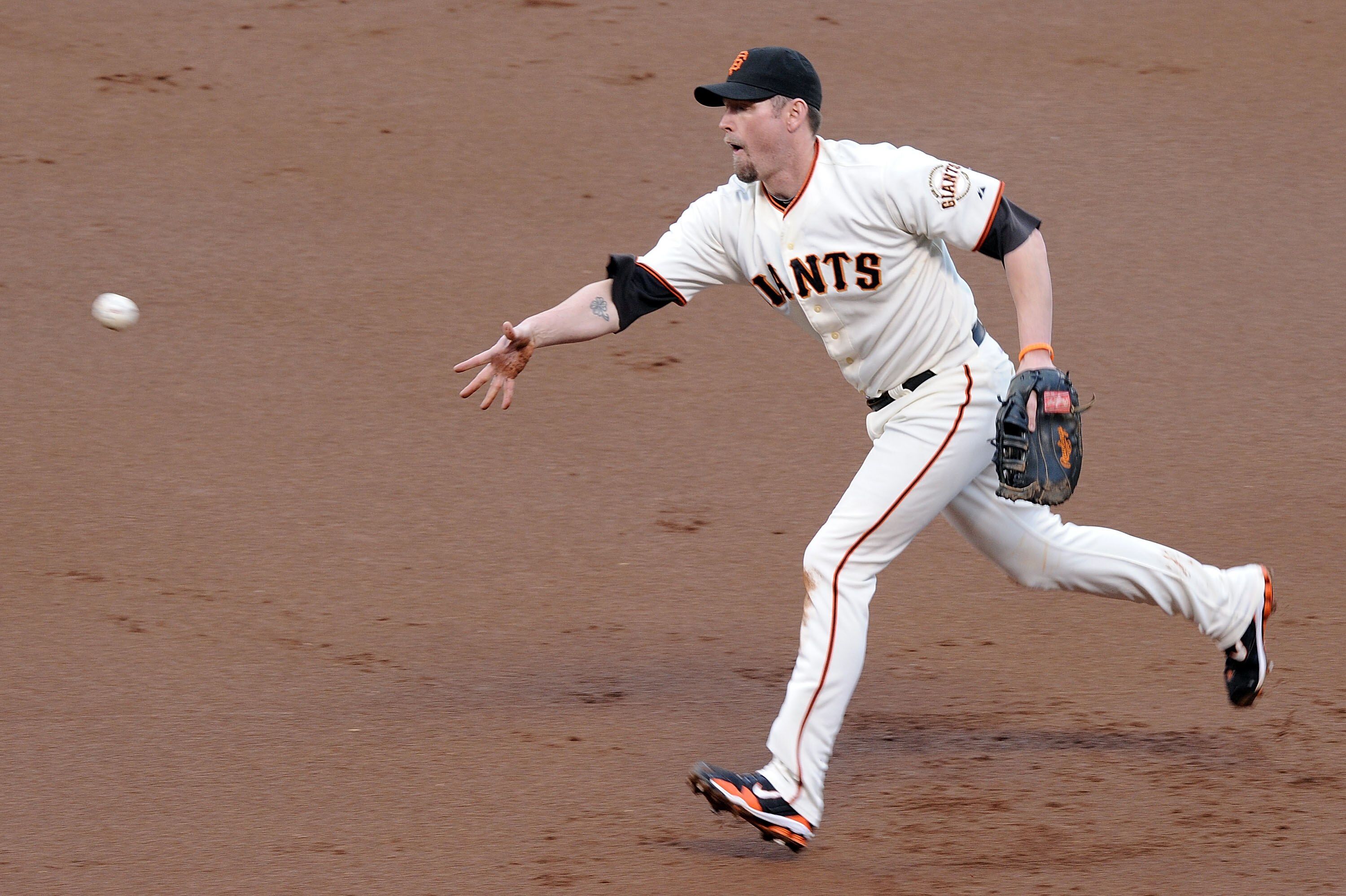 SAN FRANCISCO - OCTOBER 21:  Aubrey Huff #17 of the San Francisco Giants tosses the ball to first for an out against the Philadelphia Phillies in the second inning of Game Five of the NLCS during the 2010 MLB Playoffs at AT&T Park on October 21, 2010 in S