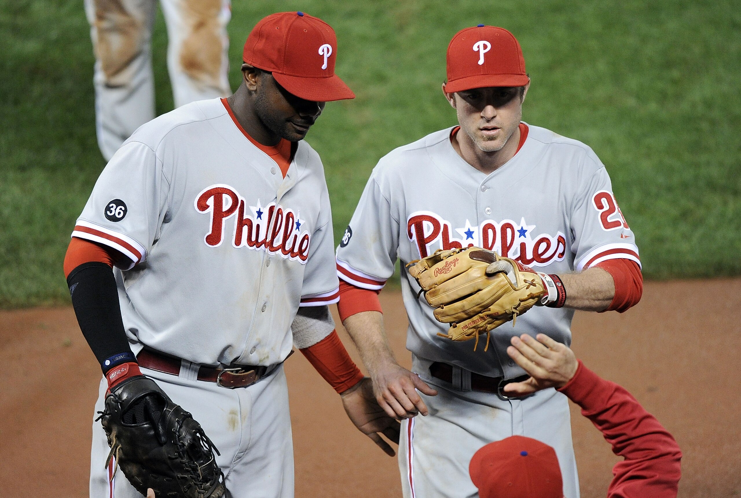 SAN FRANCISCO - OCTOBER 21:  Chase Utley #26 of the Philadelphia Phillies is congratulated by his teammates after a catch that ended the seventh inning of Game Five of the NLCS against the San Francisco Giants during the 2010 MLB Playoffs at AT&T Park on