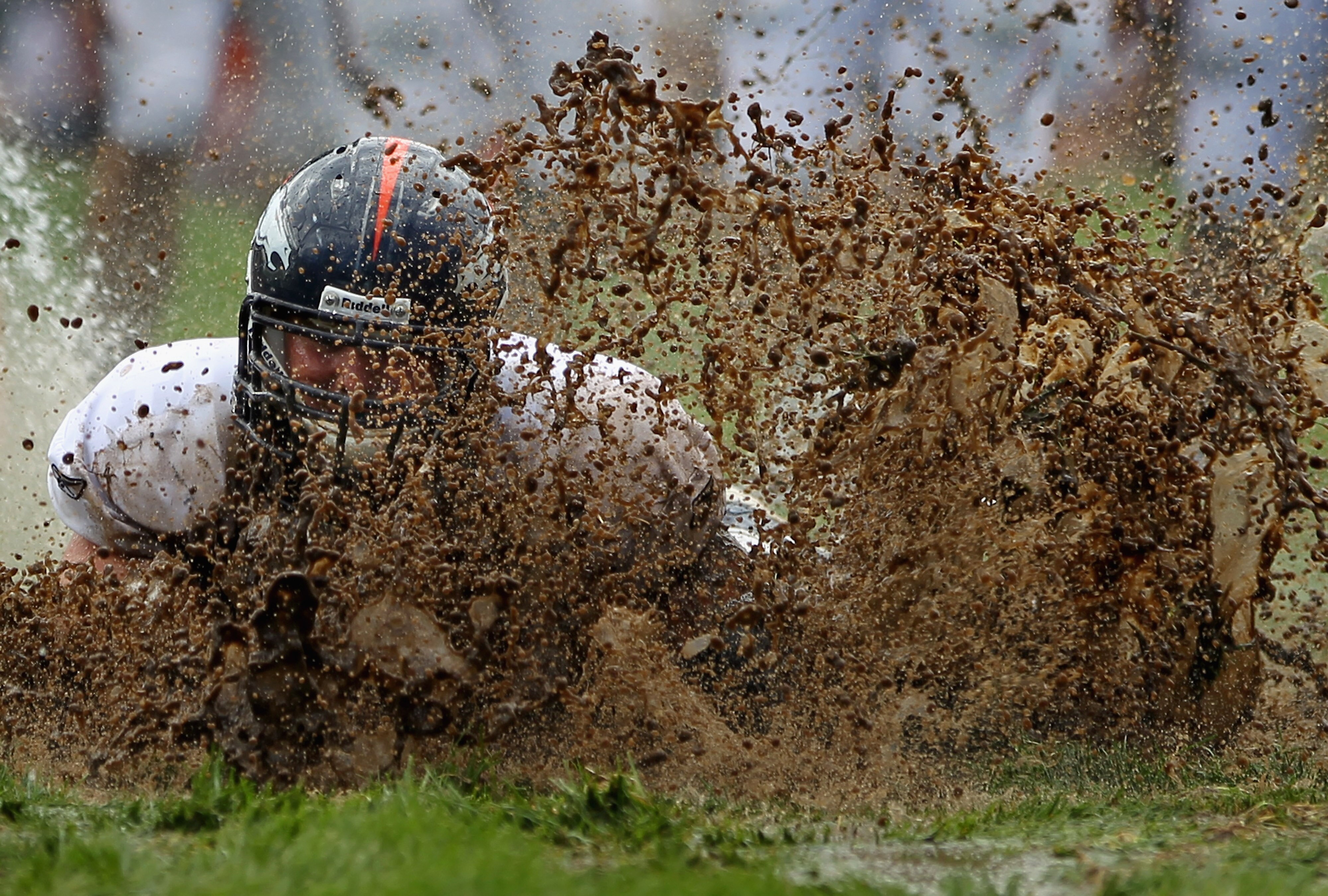 ENGLEWOOD, CO - AUGUST 05:  Zane Beadles #68 of the Denver Broncos dives into the mud as rookies partake in the slip and slide fumble drill during training camp at Dove Valley on August 5, 2010 in Englewood, Colorado.  (Photo by Doug Pensinger/Getty Image